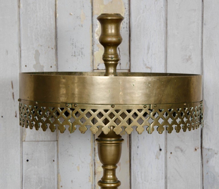 A substantial floor candle stand in solid brass. This heavy and impressive piece was reclaimed from a Greek Orthodox church in London. The circular platform would have been filled with sand for thin candle to sit in. The candelabrum has a decorative