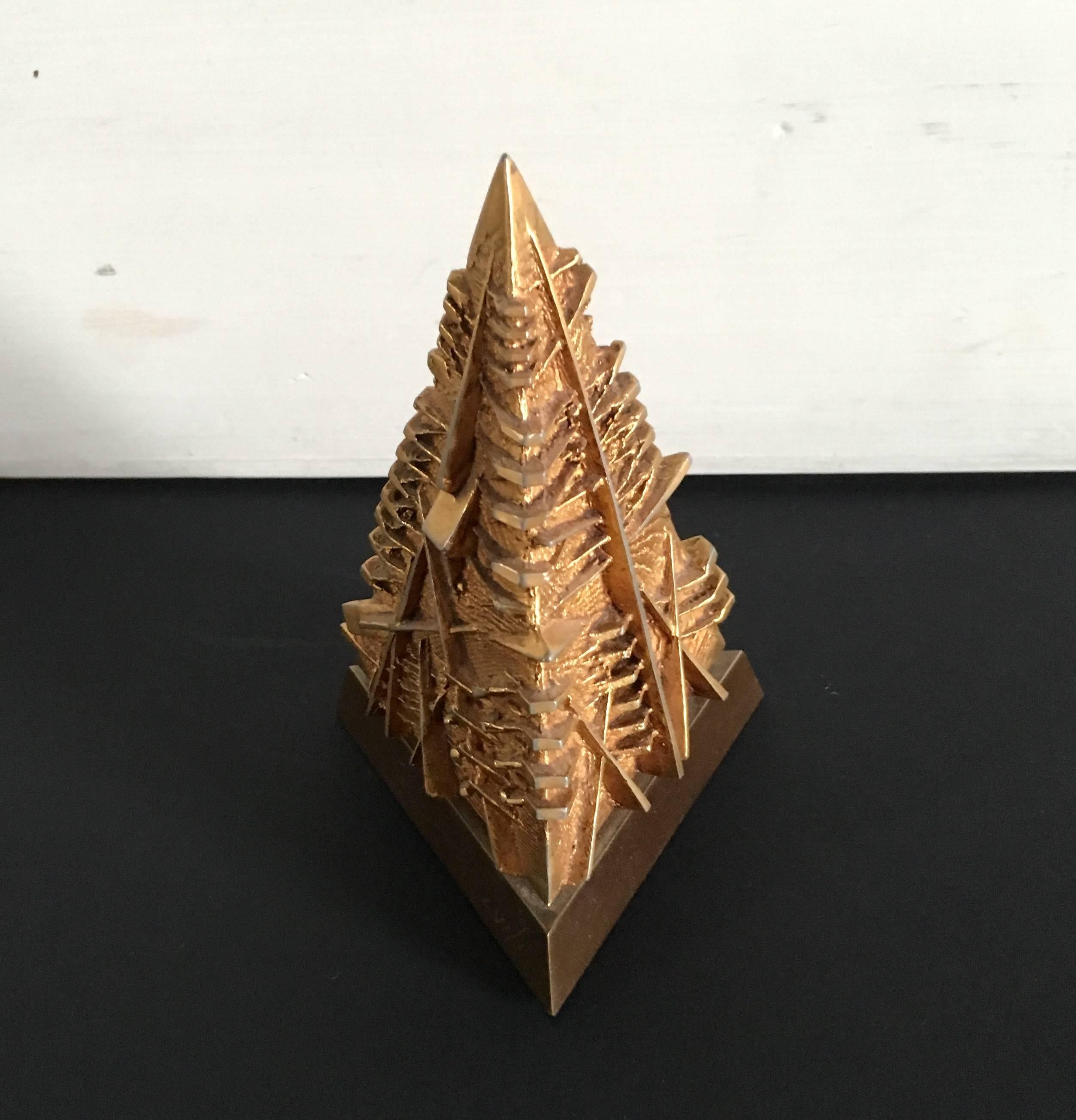 Arnaldo Pomodoro ,sculpture Piramide bronze with gold patina 
size 15 x 9.5 x 9.5 cm 
Arnaldo Pomodoro (born 23 June 1926) is an Italian sculptor. He was born in Morciano, Romagna, Italy. He currently lives and works in Milan
Pomodoro designed a