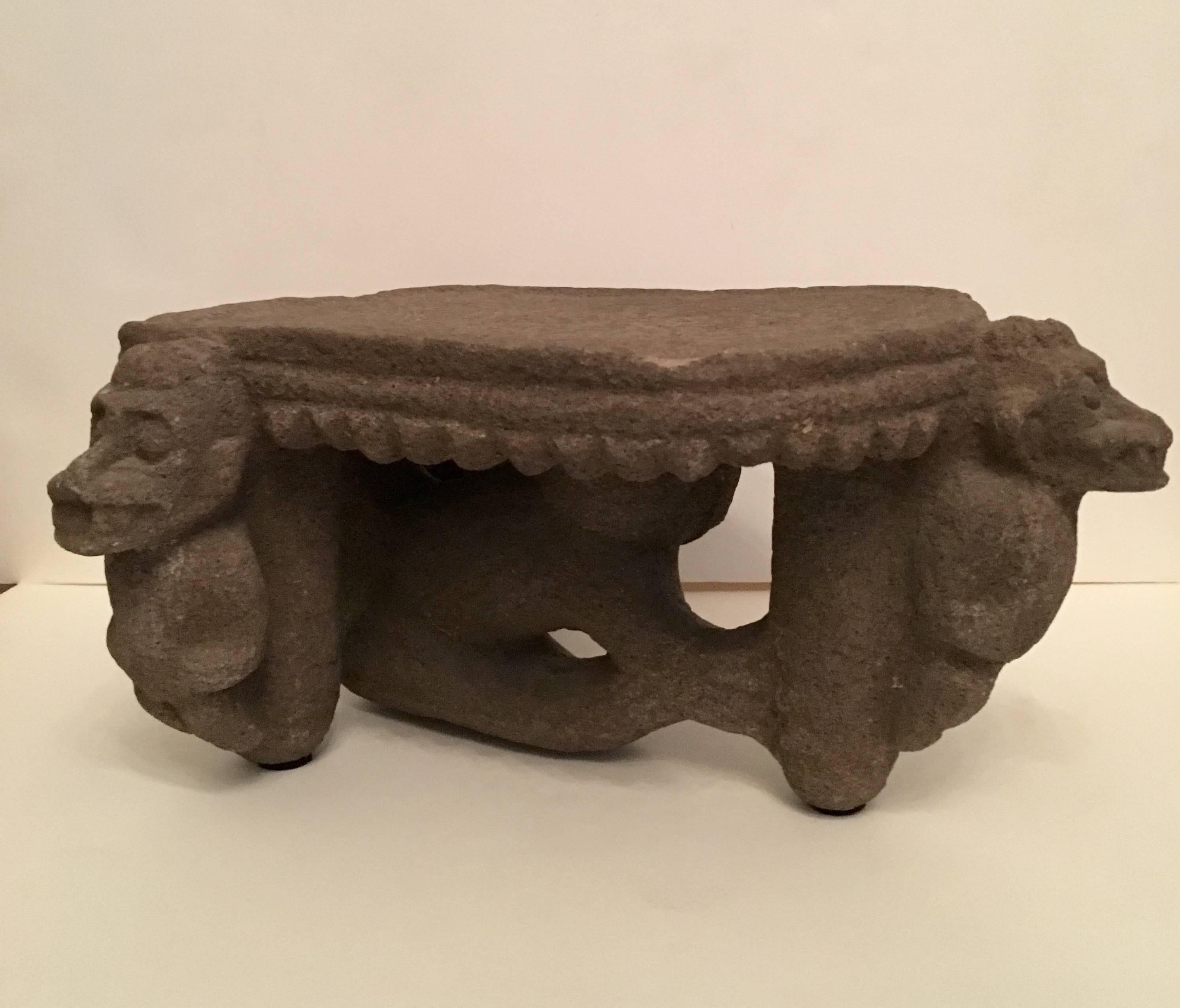A Costa Rican Metate circa 300-700 AD, the Volcanic stone implement carved in bold relief to depict 3  standing zoomorphic  crocodiles figures ,emerging from each of the tripod columnar legs,a jaguar figure stands underneath the flat table