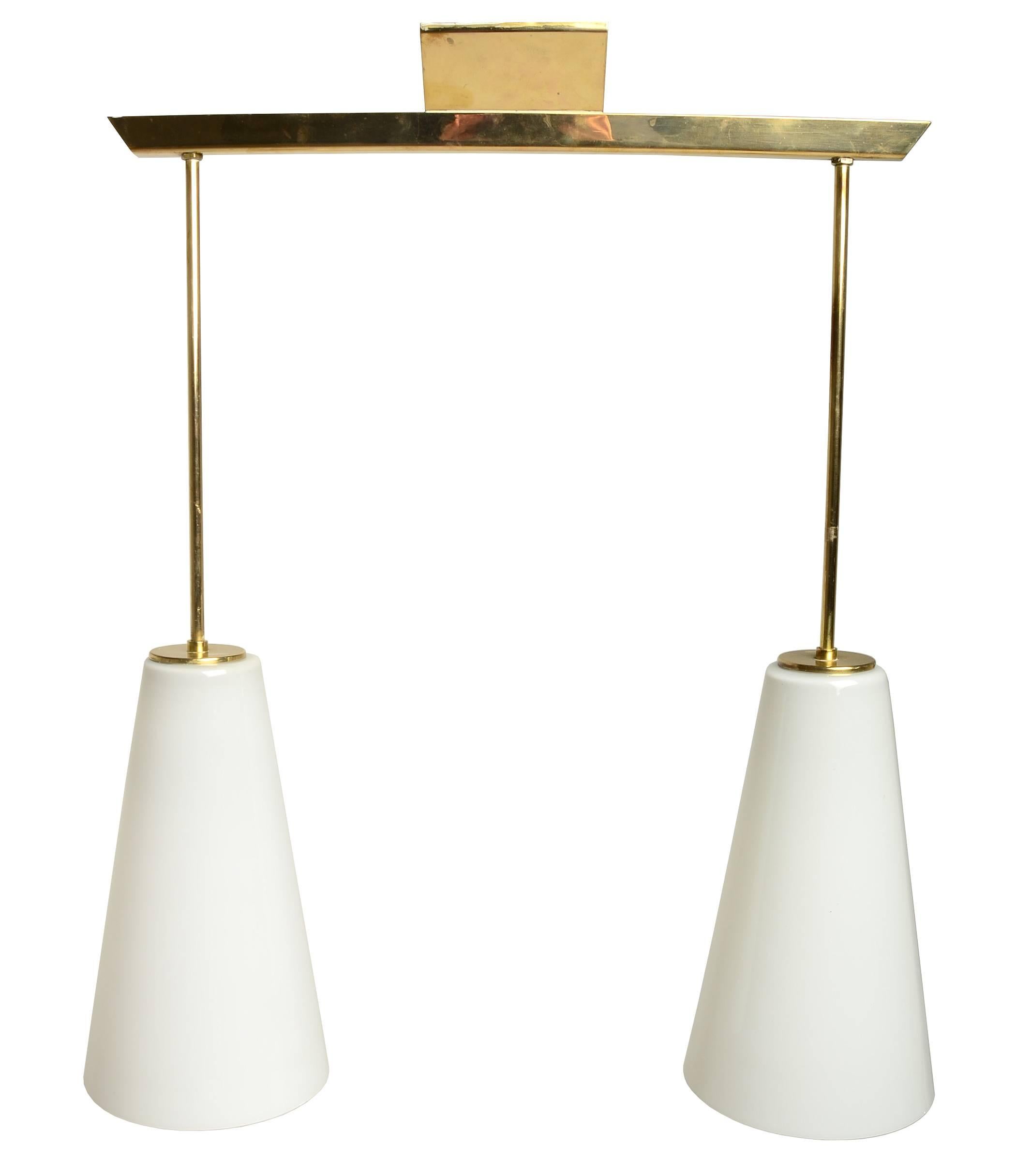 Such an incredible example of Paavo Tynell's lighting designs. 

This example is rather unusual and comes with the original custom ordered glass shades.

Simple and Classic. Solid brass and glass.

Made by Taito Oy. Model number 1995.

  