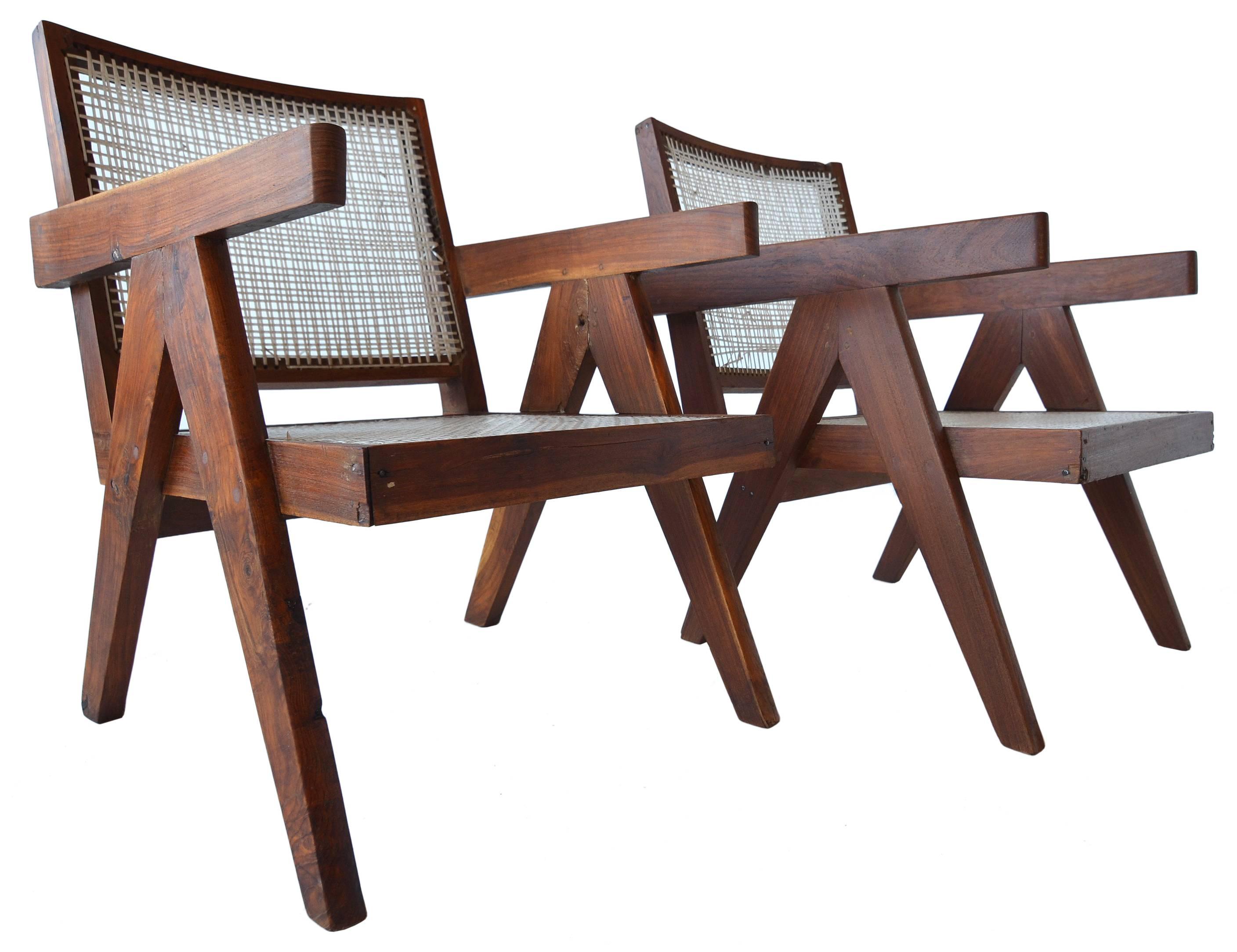 A great pair of easy chairs by Pierre Jeanneret for the Chandigarh Project.

This pair is lightly and sympathetically renovated. A simple cleaning and waxing was performed to bring out the color and grain of the wood. 

These two chairs retain the