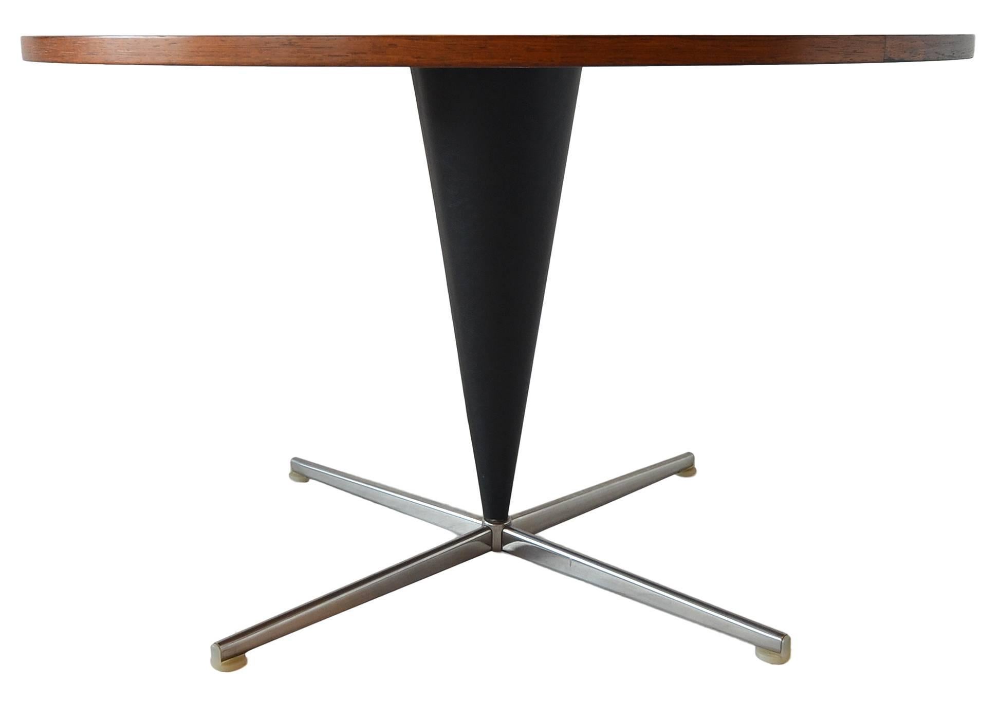 Very few of these unusual cocktail tables were ever created. Even fewer in Rosewood. 

This table was made by the firm Plus Ligne in 1959. 

Rosewood top with black vinyl covered base.
        