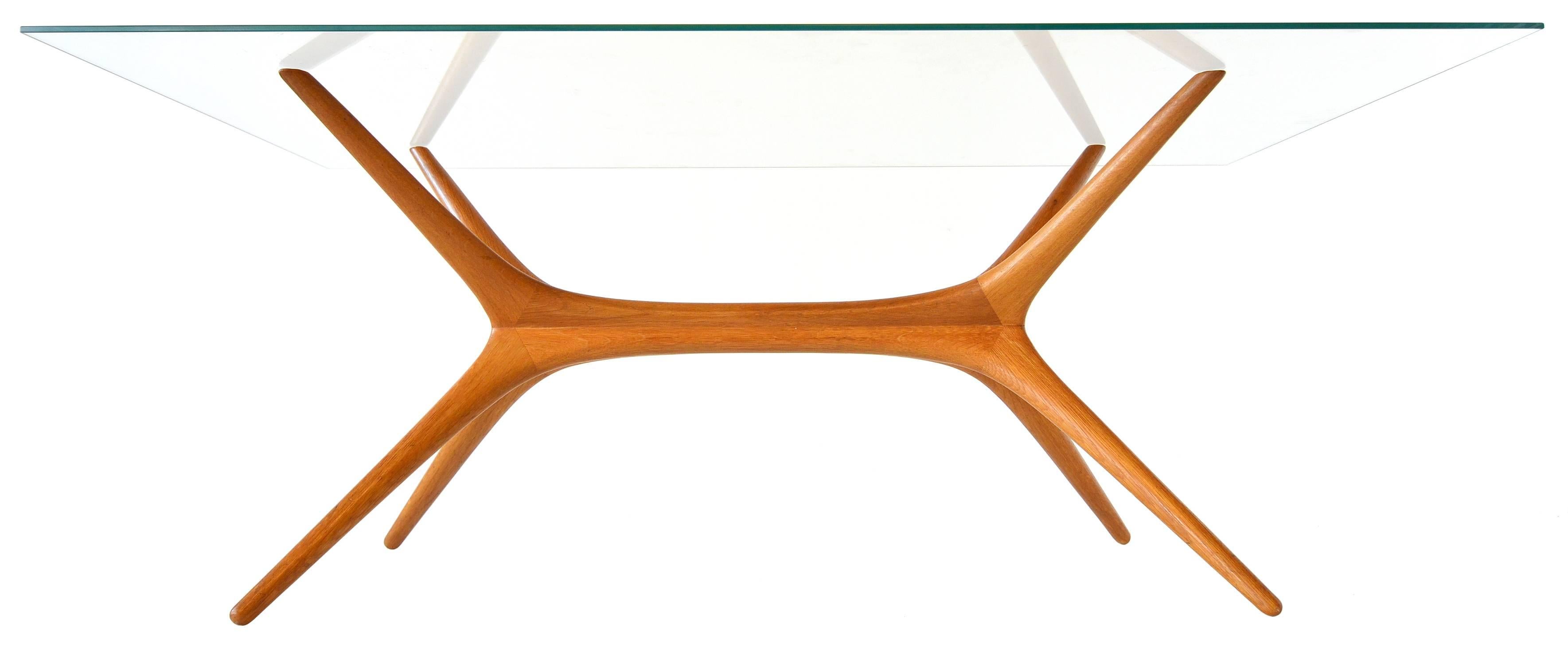 Designed for Asko, Finland in 1958.

These tables are highly sought after and regarded as Tapio Wirkkala's most important production furniture. 

Made from hand-sculpted solid elmwood in four parts. Each quadrant is the exact same form which