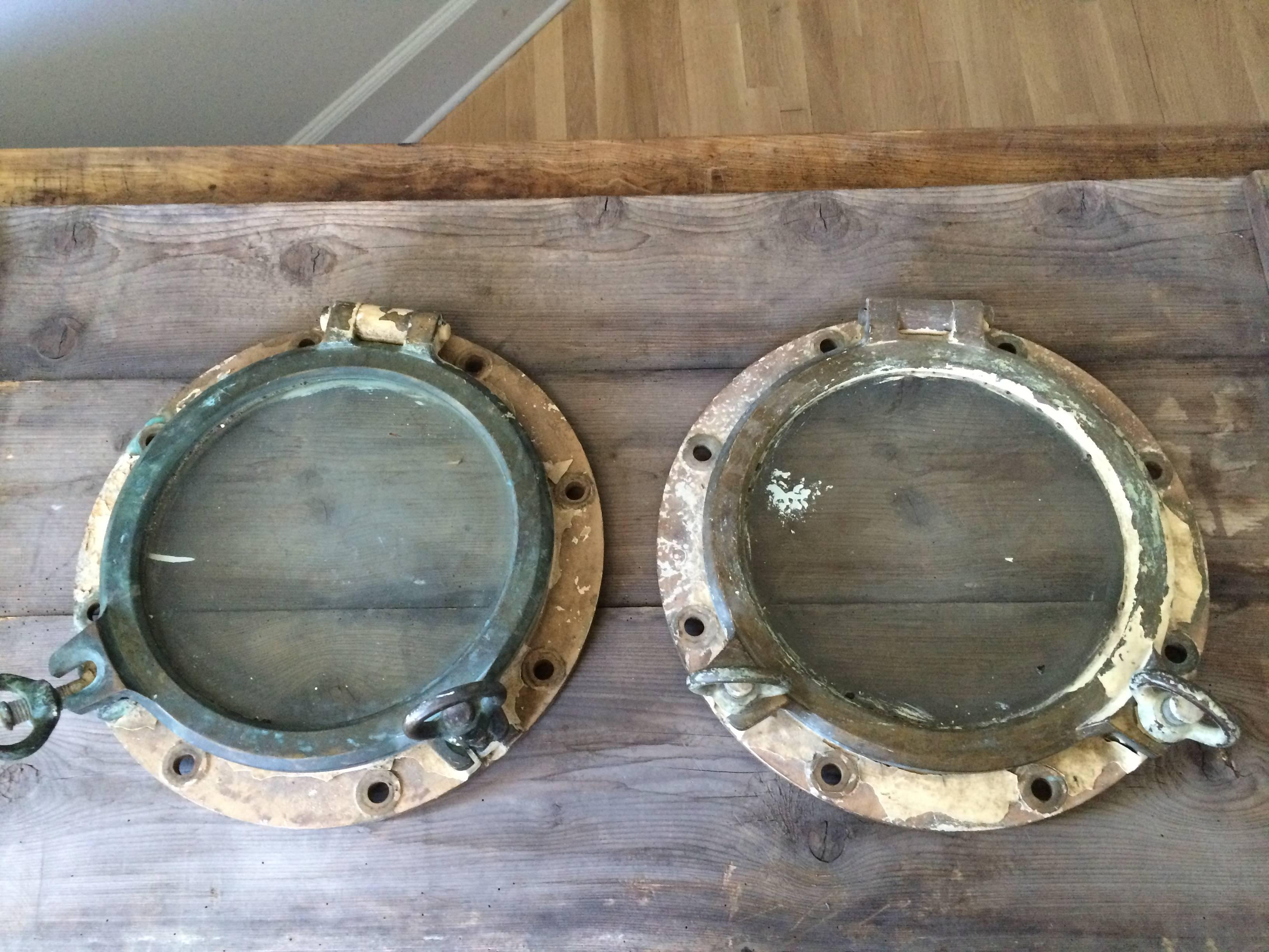 Pair of bronze French portholes from the south of France. They are very heavy and in working order. Would be great cut into a door or wall or made into mirrors.