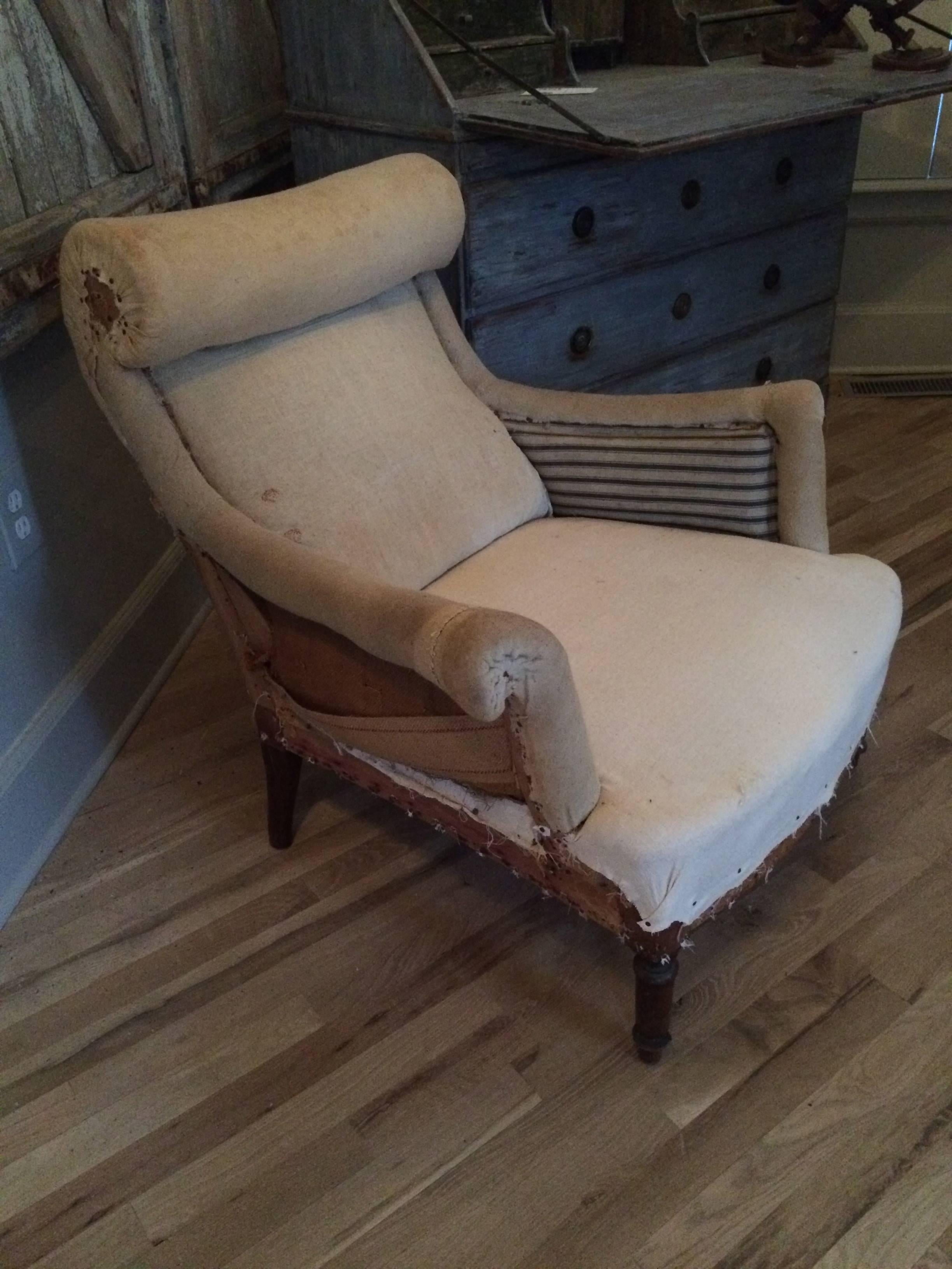 Unique pair of scroll top French salon chairs with original muslin.
