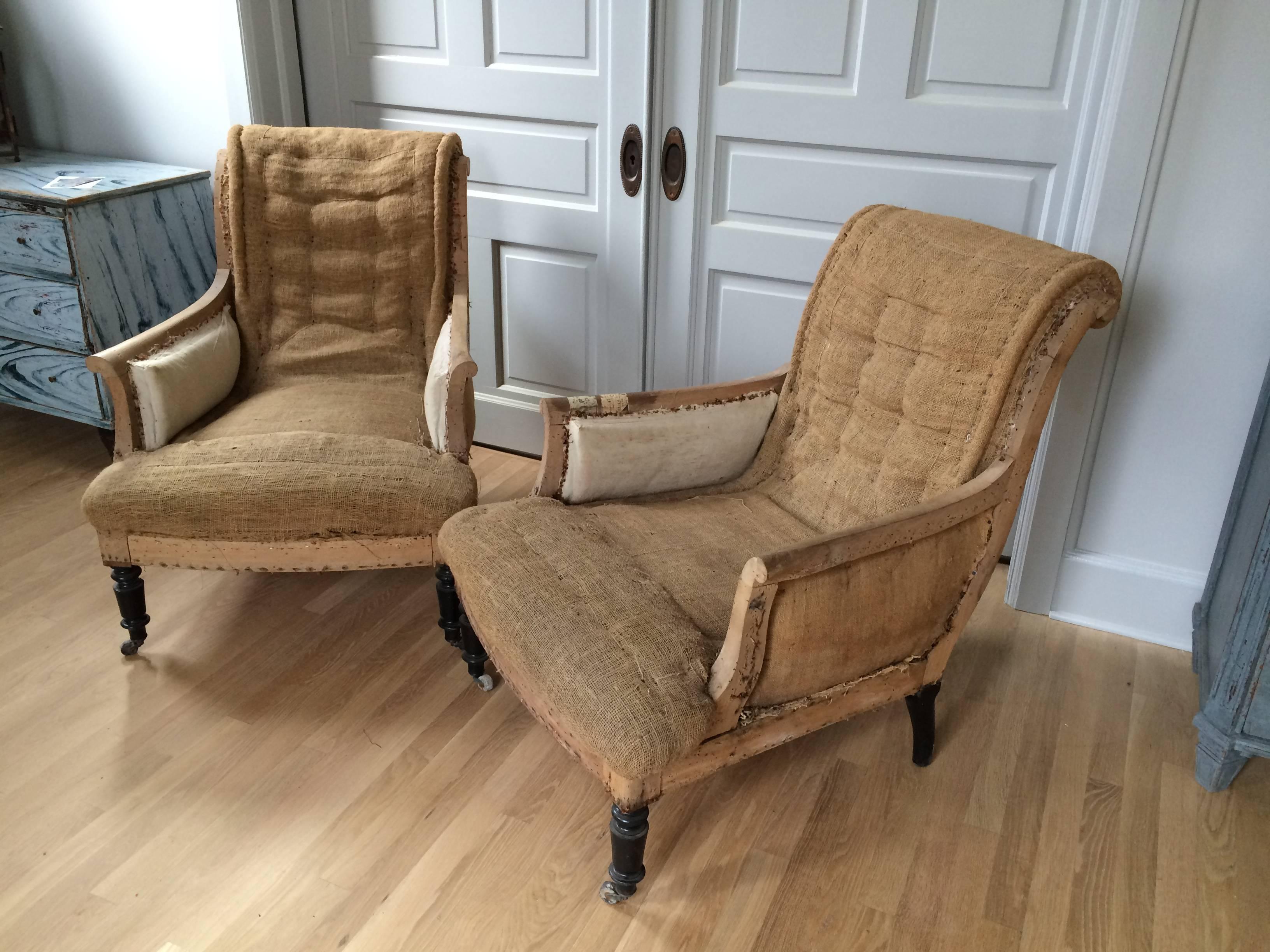 Pair of Napoleon III tufted armchairs, French, 19th century. The chairs have been stripped down to the original burlap and muslin and retain their original stamping, see photos. Elegant and comfortable as is.