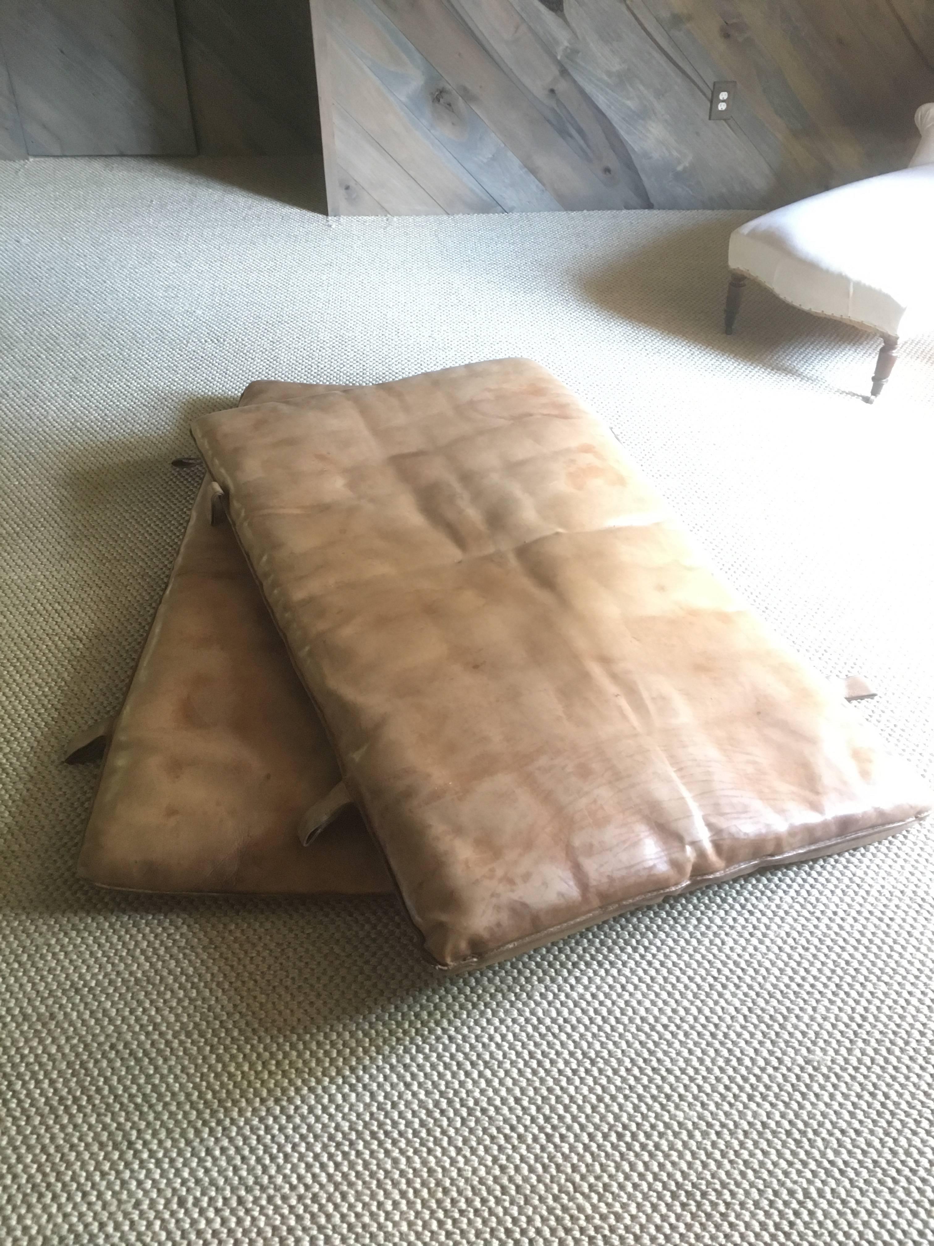 A pair of vintage gym mats originally from the Czech Republic. Each has four double loops which would be ideal for hanging as a headboard or banquette back. Sold individually. Each has a wonderful patina.