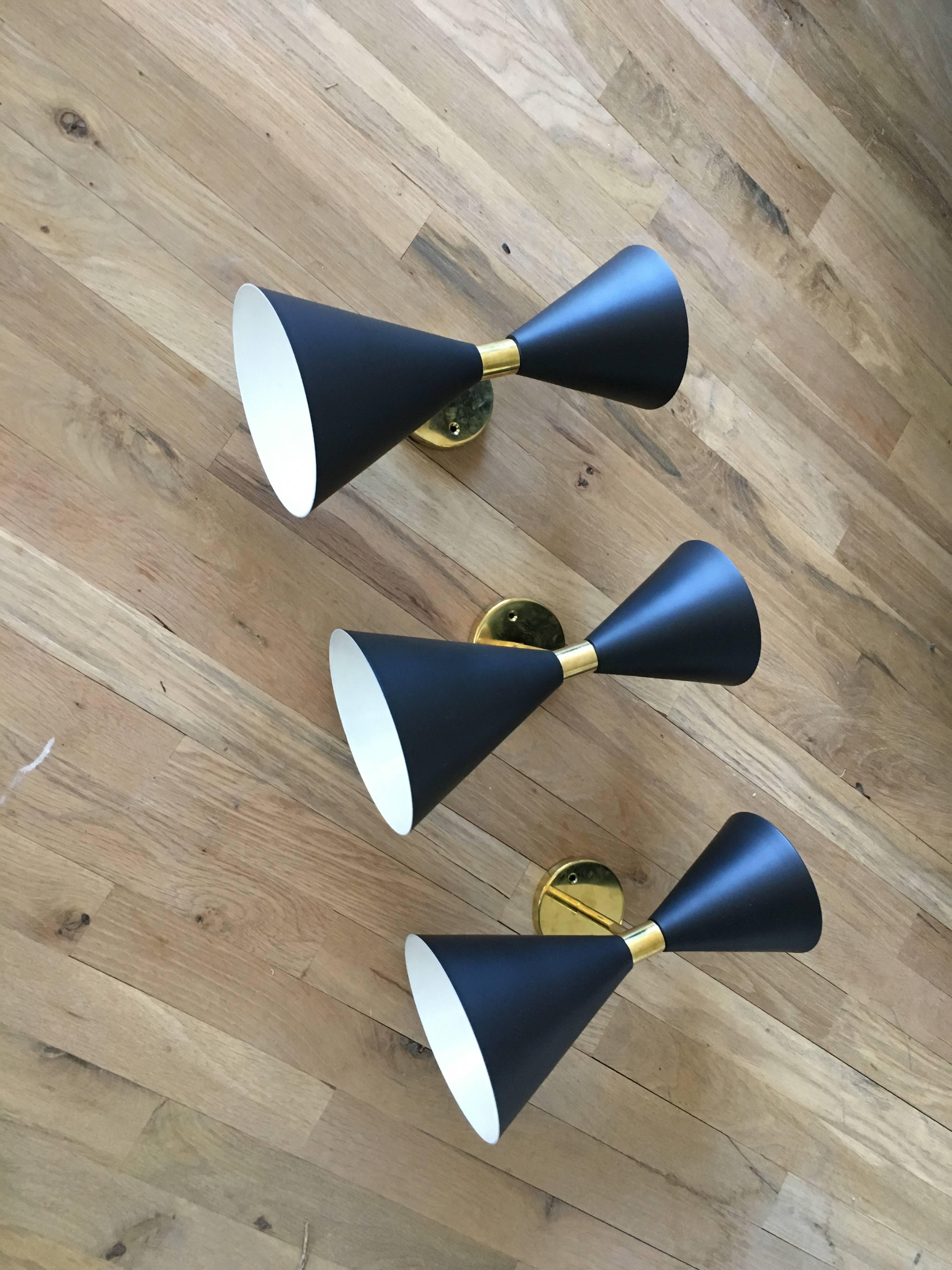 Three Italian Mid-Century Stilnovo sconces. Light emanates from above and below. Two bulbs. Can be purchased individually; price listed is for one sconce.