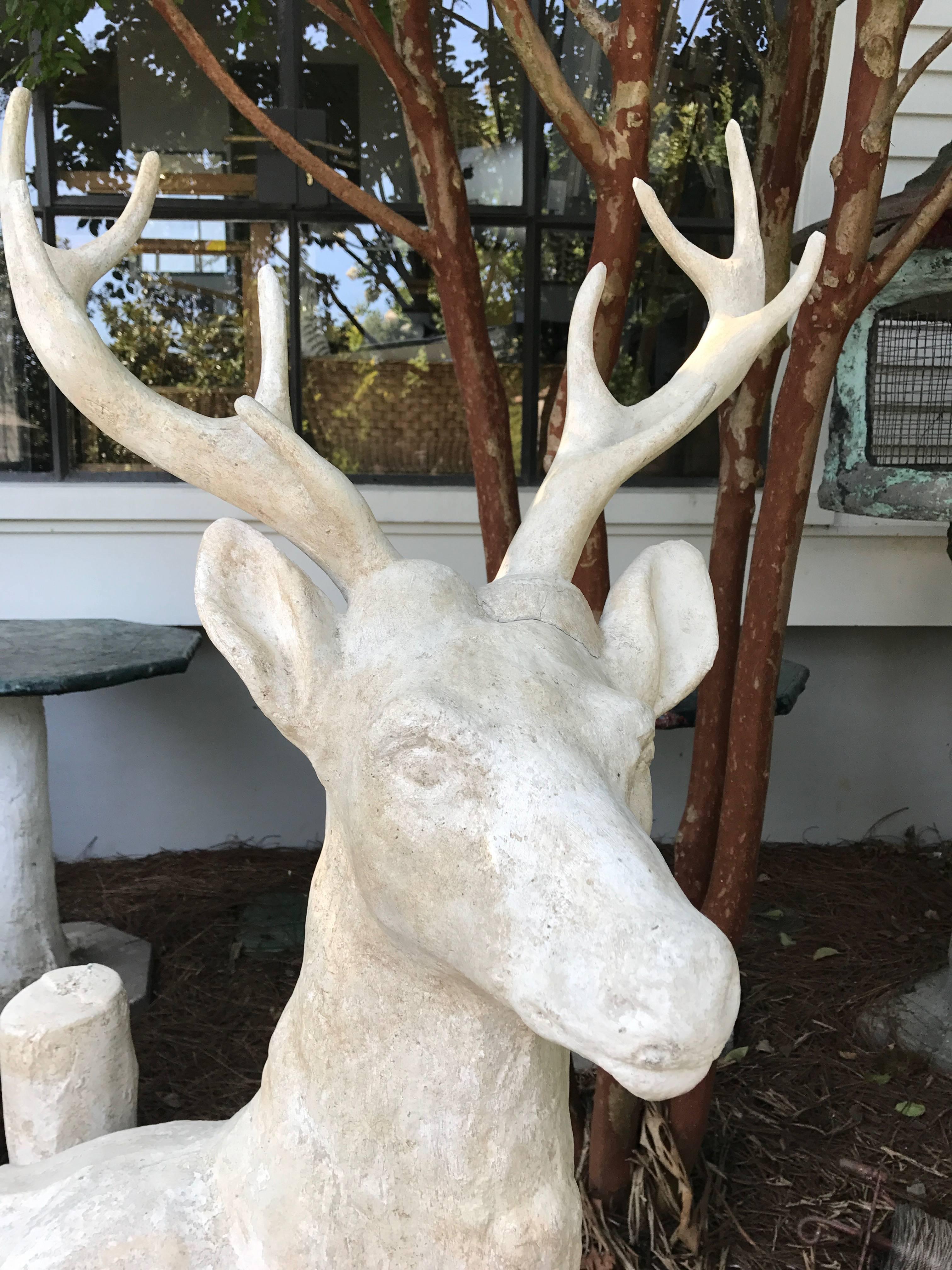 Cement stag statue standing by a tree. This was found in the south of France in an estate garden. This item is deeply discounted for our moving sale!