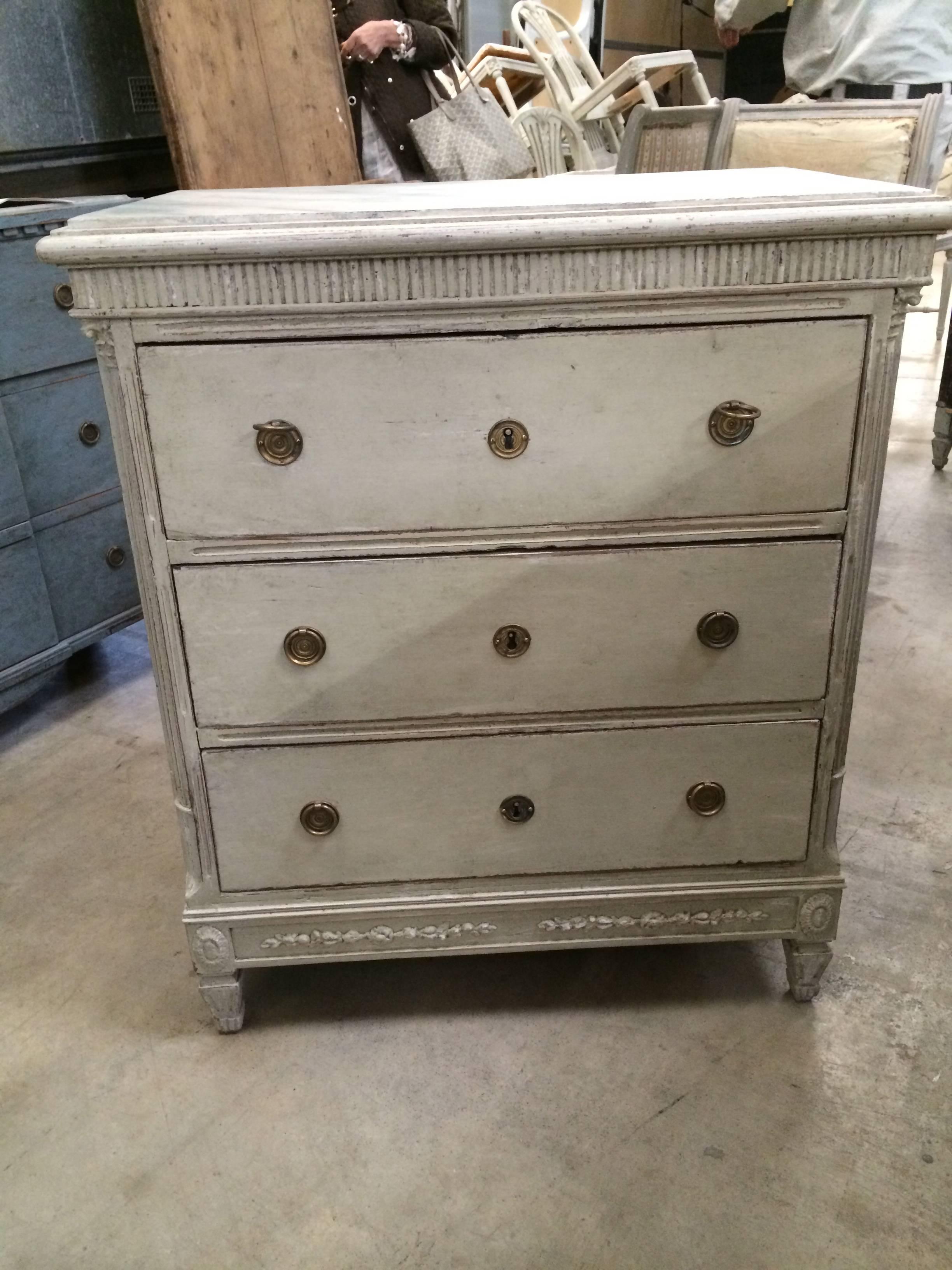 18th century Swedish three-drawer painted chest with faux marble painted top and fluted carving. Original ring handles.