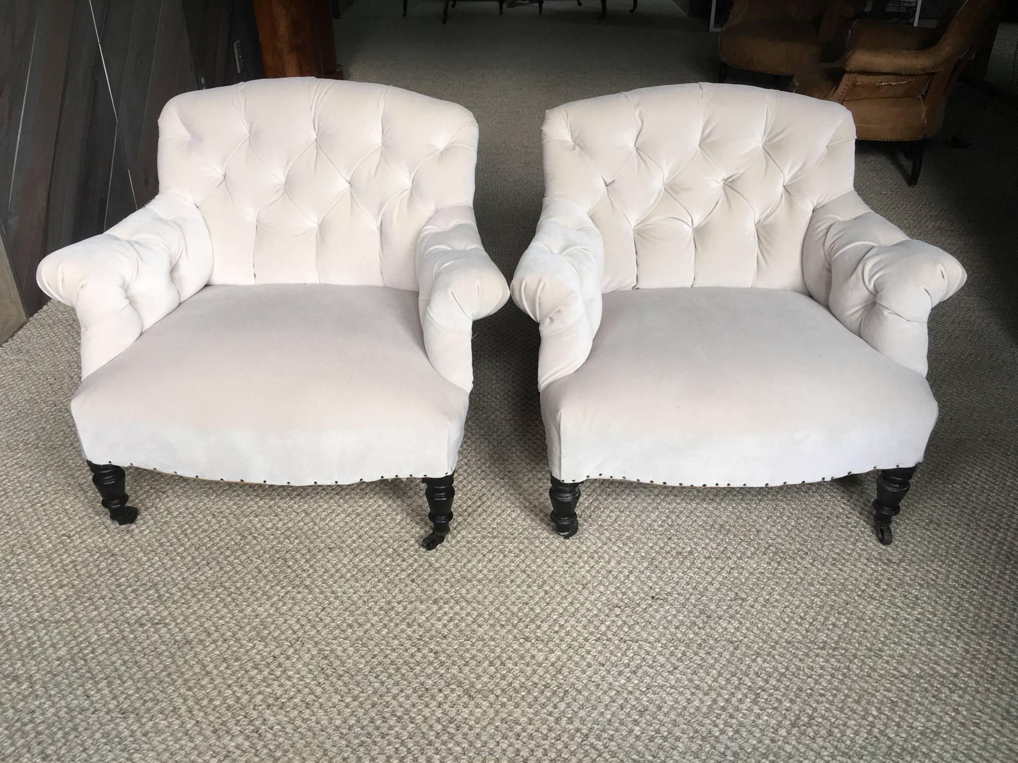 Pair of fabulous antique French tufted salon chairs upholstered in "cement" velvet leaving the backs and side framework exposed to show architecture, age and authenticity. Priced separately.