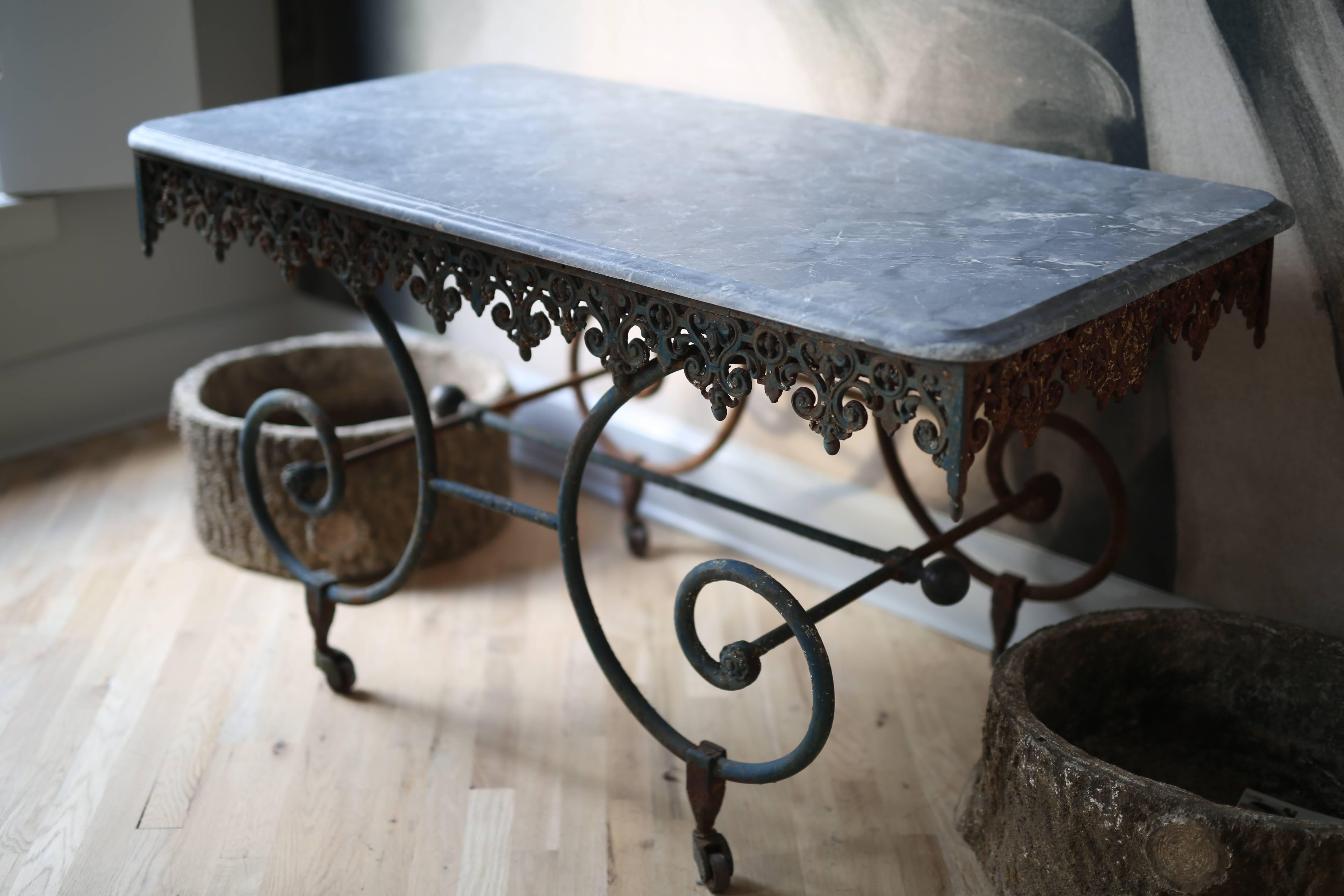 Exceptional wrought iron French Butchers display table with black marble top. Used in the window of a butcher shop to display the Butchers best cuts of meat. The ironmongery, brass details and patina on this piece are exquisite. Dating from the