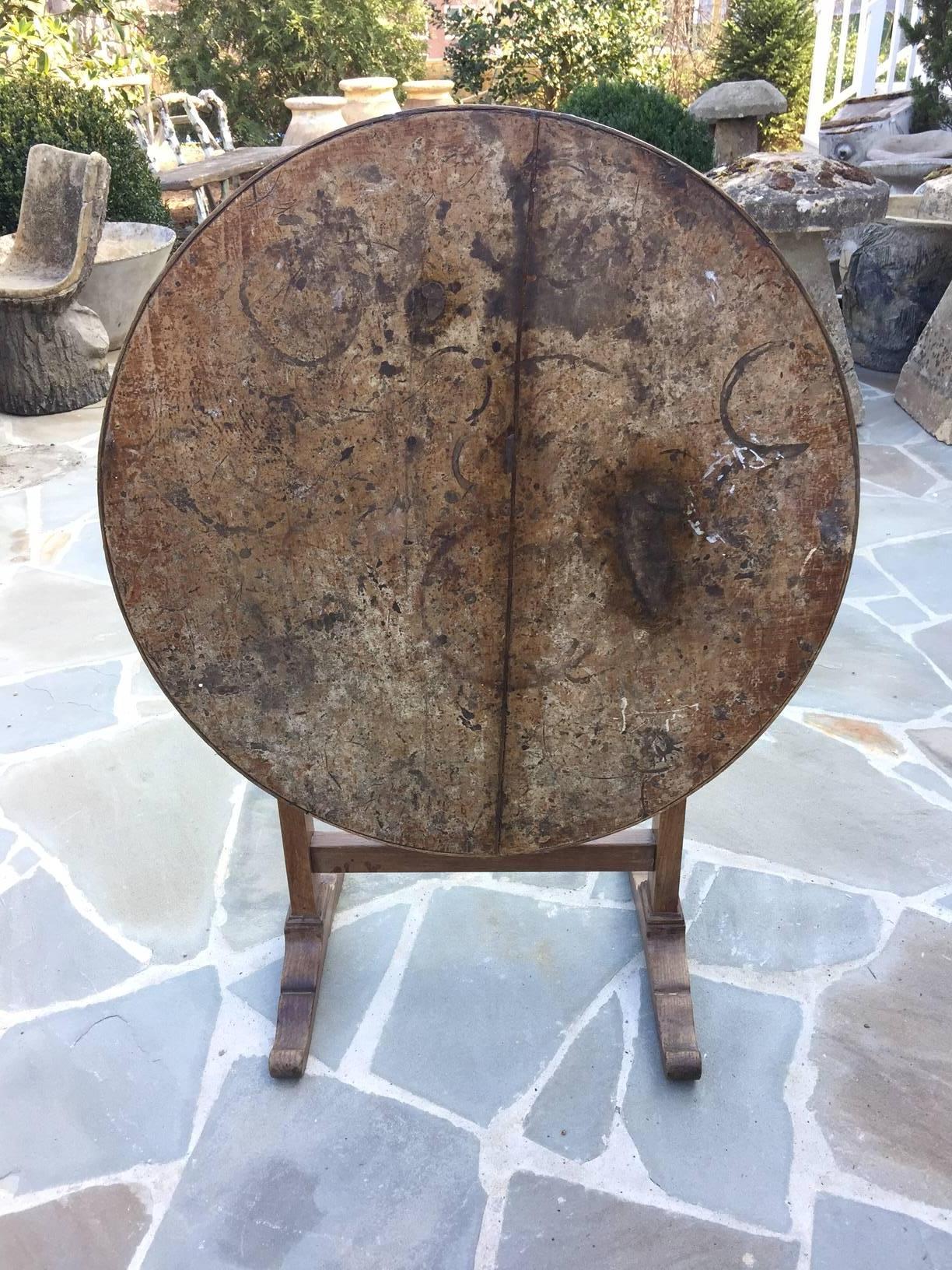 19th century French oak wine tasting tilt-top table. The fabulous unique patina comes from over a century of use. Truly a character piece.