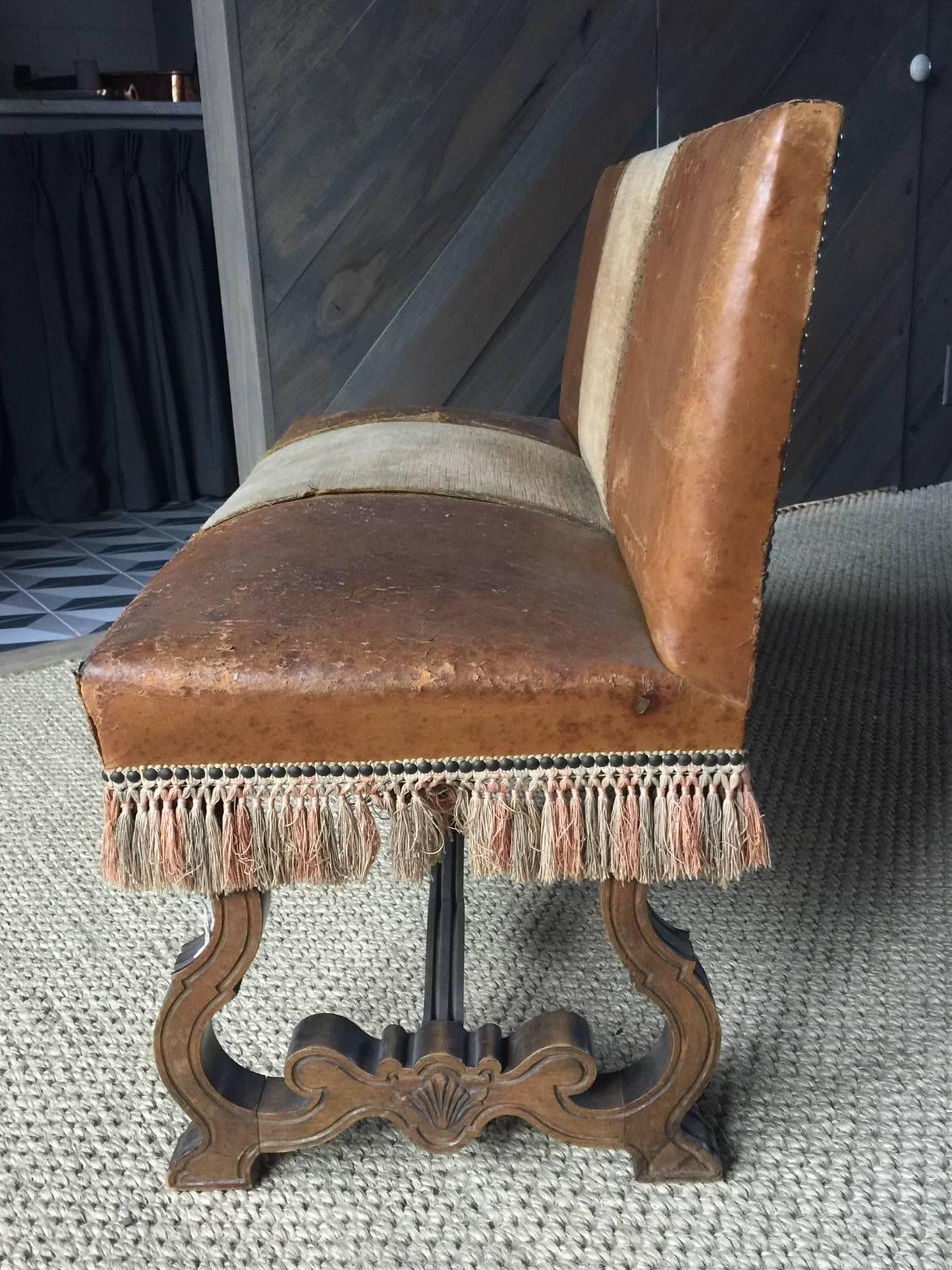 Very stylish Petite Spanish leather bench with fringe and nailheads, late 19th century Baroque style, all original.