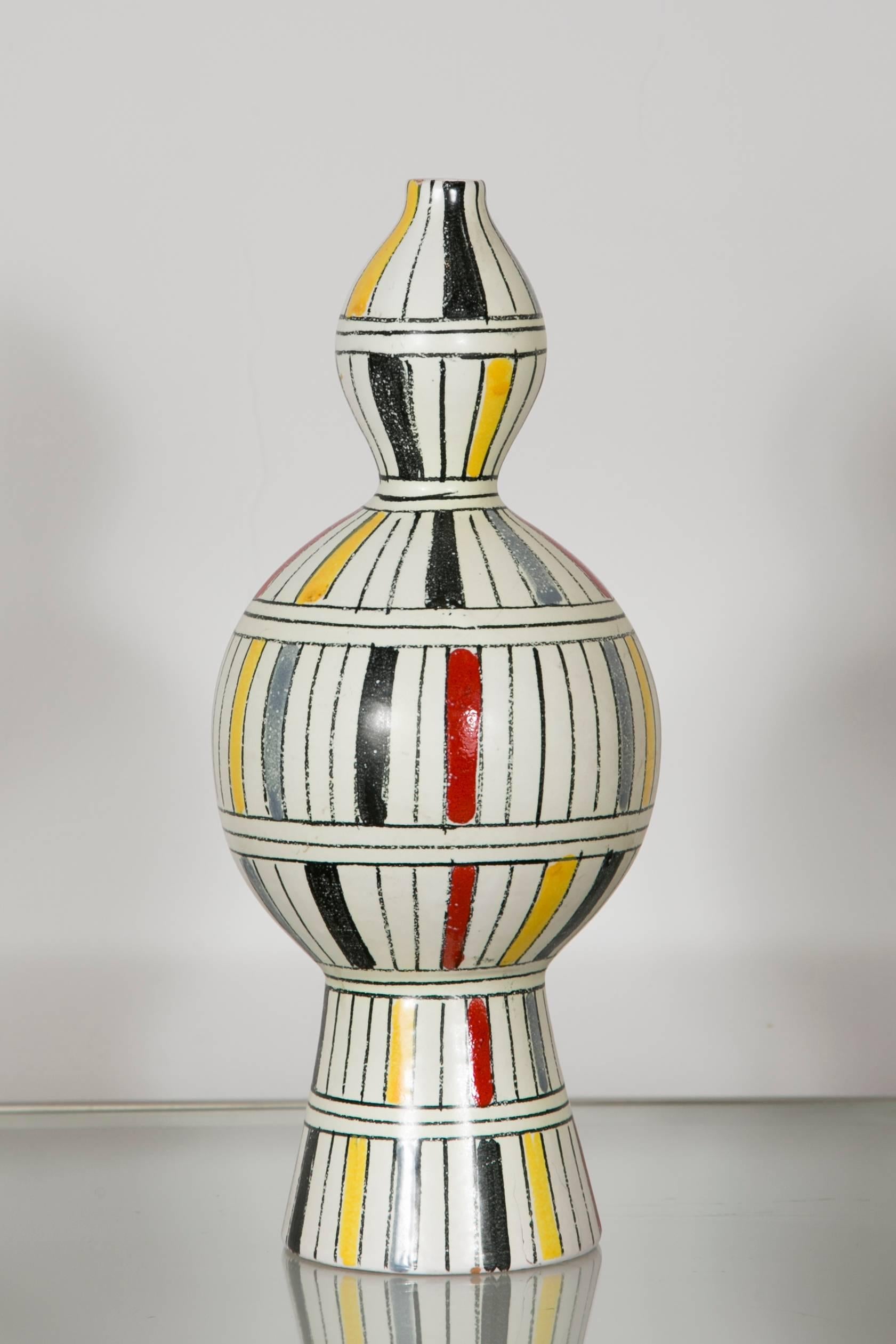 Ceramic vase decorated with striped polychrome pattern.
In the style of Raymor,
Marked: 3030/406 Italy
Italy, 1960.

 