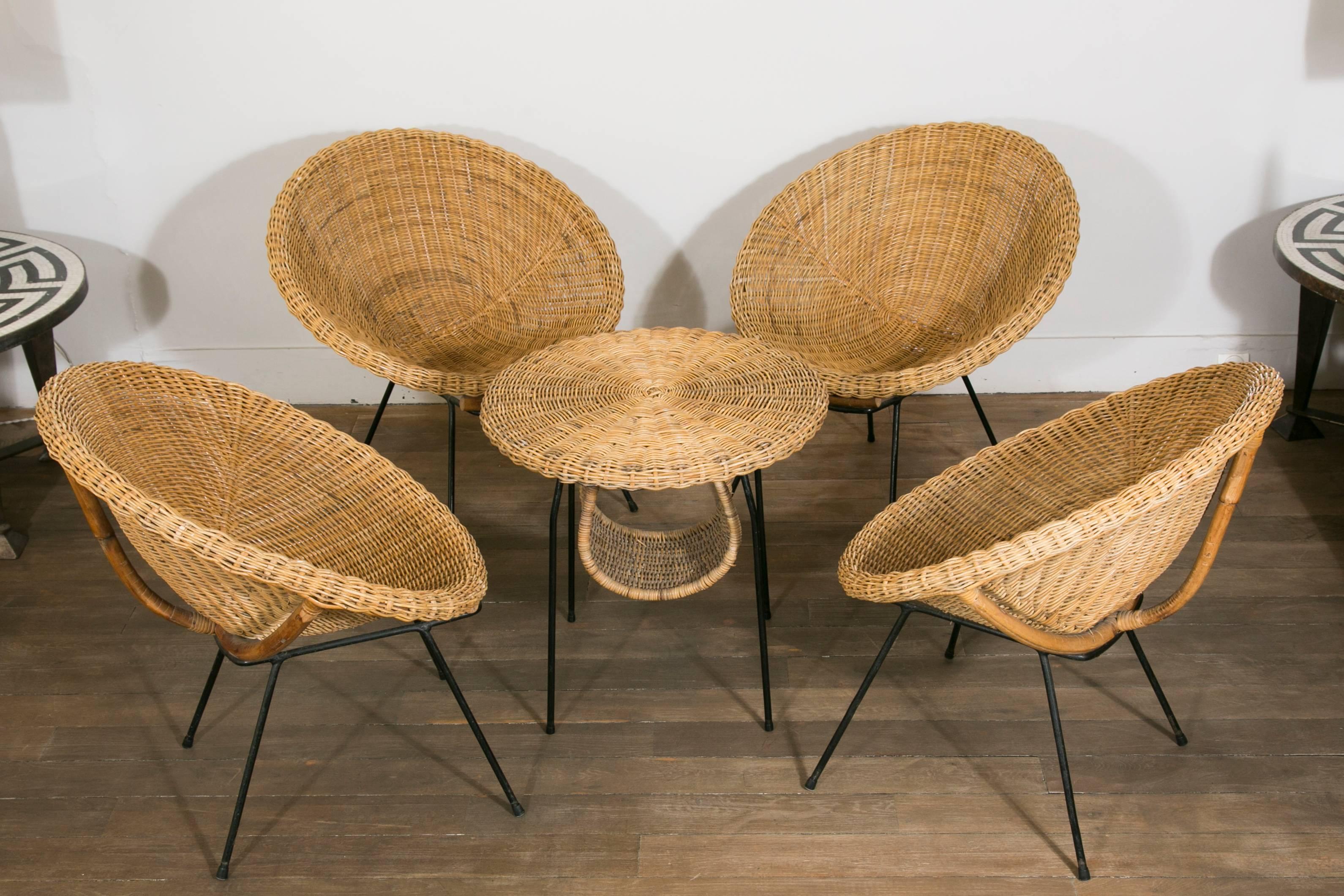 Rattan and bamboo set of four scoop chairs and one magazine table.
Lacquered metal feet.
In the style of Janine Abraham.

France, 1960s.
 Chairs dimensions:
Height 28.3 in.
Width 25.2 in. 
Depth 28.3 in. 
Heigtht seat 15.3 in.

Table