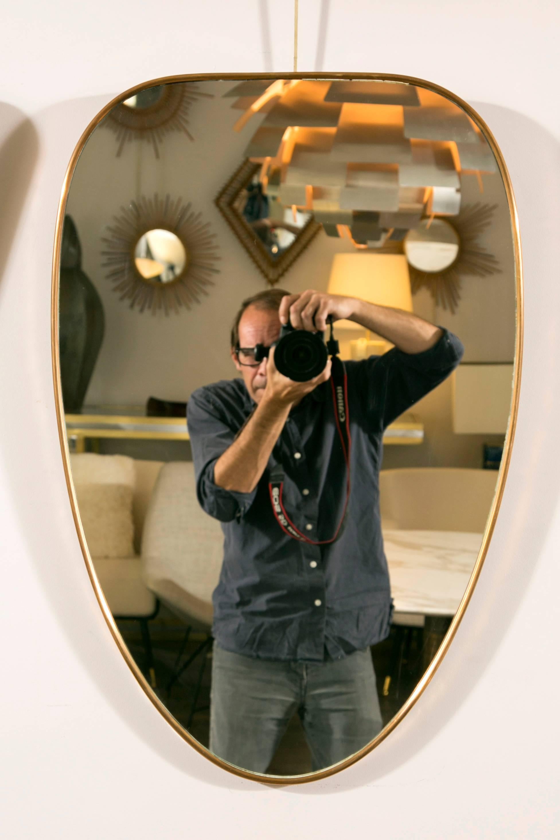 A collection of ten wall mirrors, brass frames, various size and shapes in the style of Gio Ponti. 
Italy, circa 1950. 

Dimensions of the top line, from left to right: 
Height 75 cm, width 54 cm 
Height  77 cm, width 51.5 cm 
Height 74cm,