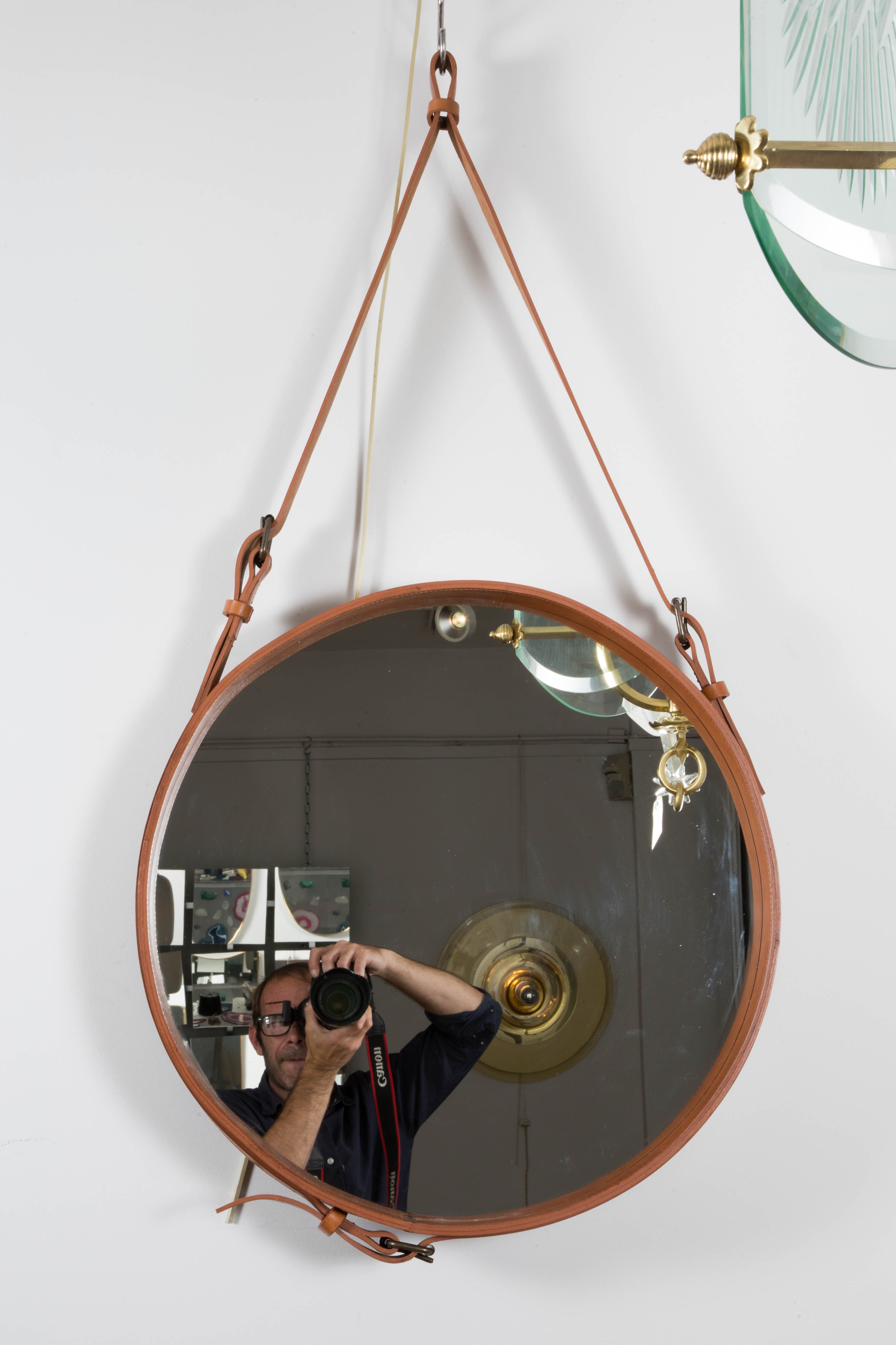 A leather Adnet style mirror .