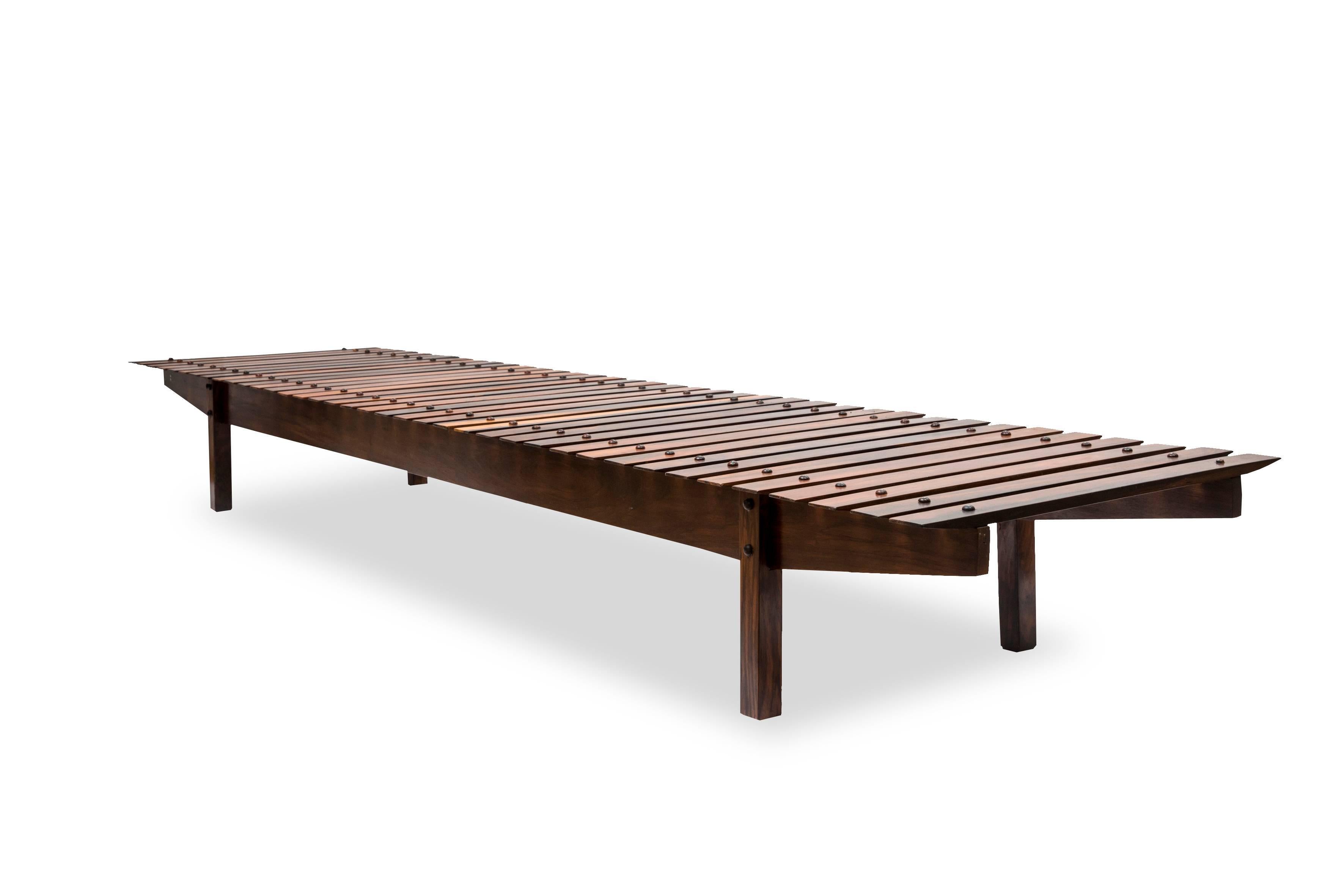 A rosewood bench, rectangular slabs on square legs.
This bench can equally be used as a coffee table. 

Designed by Sergio Rodrigues. 

Brazil, circa 1960.
