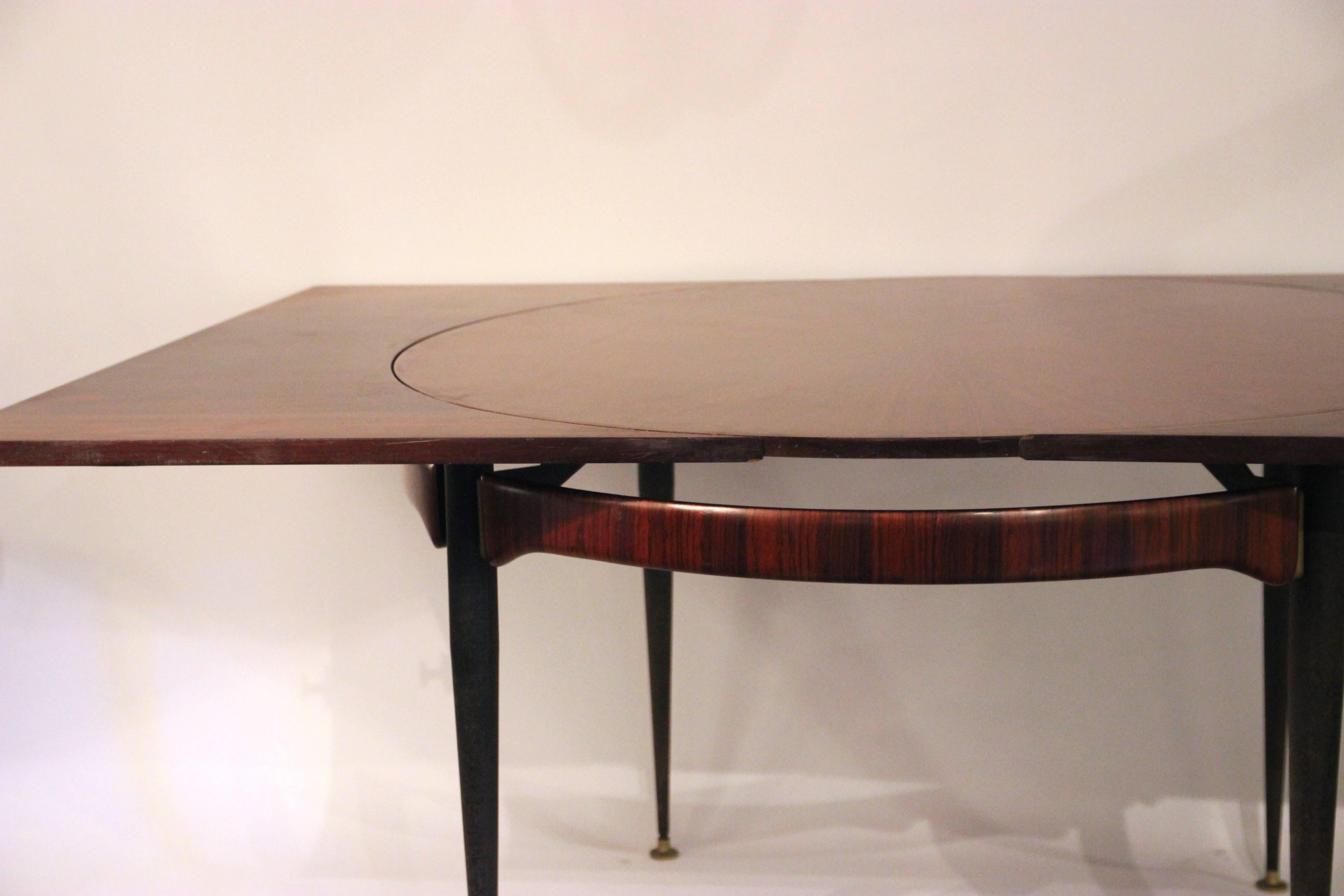 Attributed to Franco Albini (1905-1977),
Dining table (four covers without extension, eight with extensions),
Rosewood, iron and gilded brass,
circa 1970, Italy.
Round table without extension: Diameter 120 cm, height 74 cm,
table with
