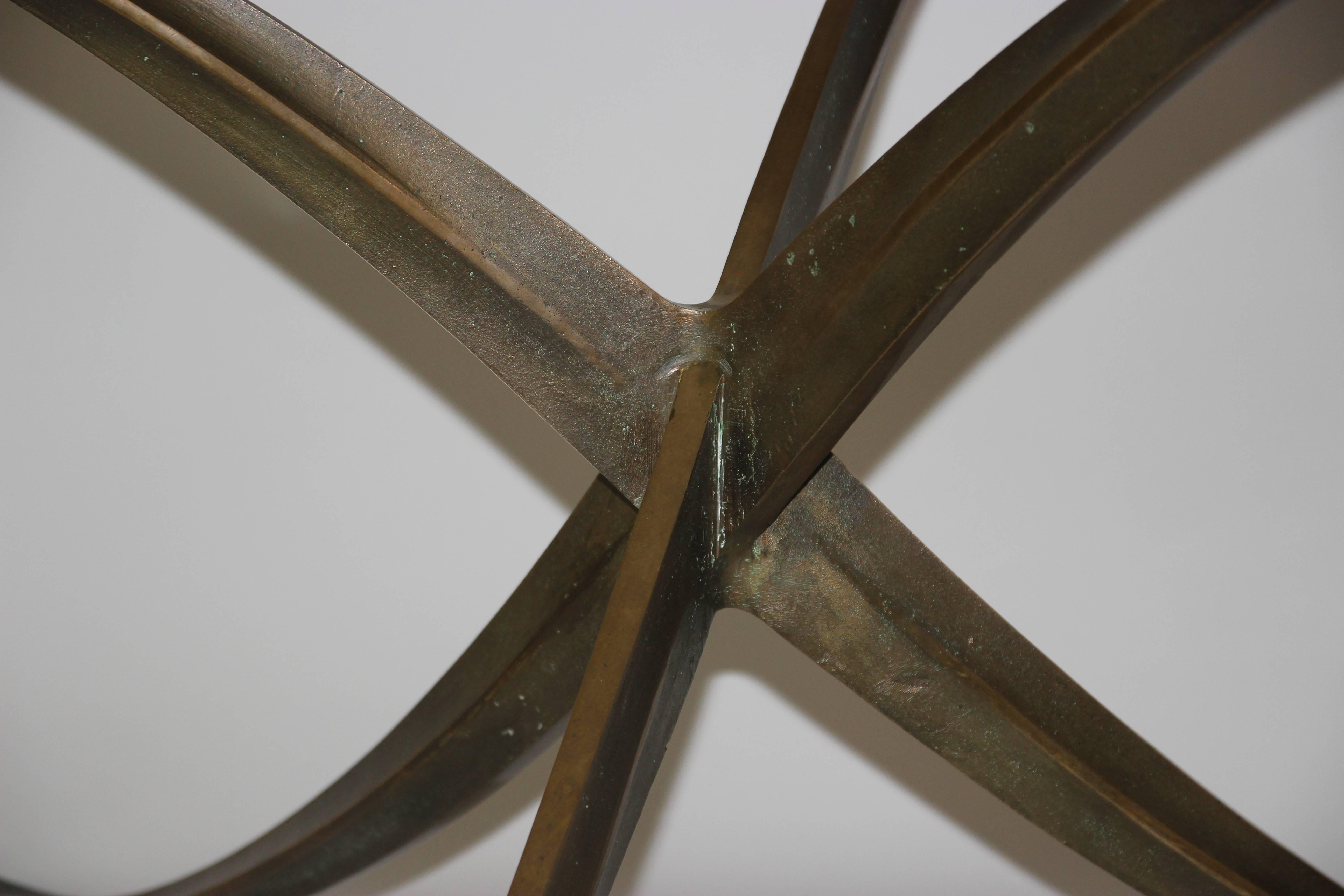 Michel Mangematin (1928), dining table, 
gilded bronze base of freeform,
circular glass tray,
circa 1960, France.
Measures: Height 70 cm, diameter 131 cm.