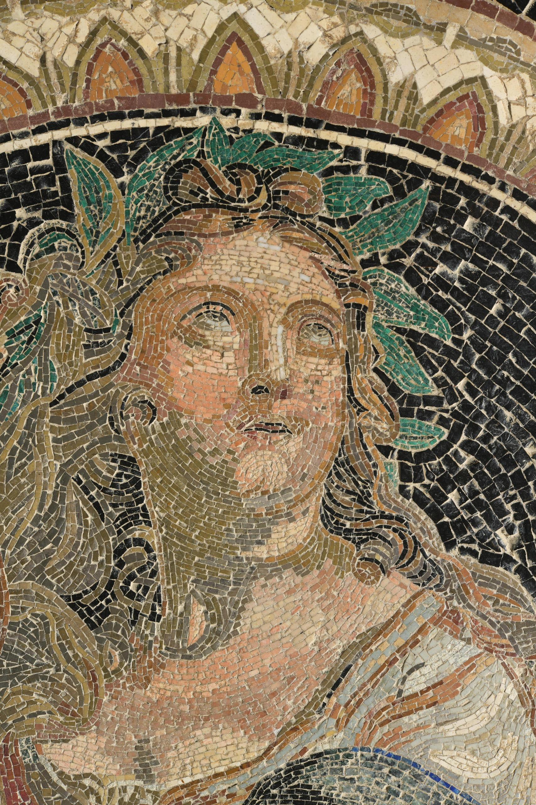 Marble tabletop decorated in the center with a mosaic of concentric friezes featuring plant and geometric motifs. The central medallion, made of hard stone micromosaics, depicts Apollo with a lyre. There is a slight difference in level between the