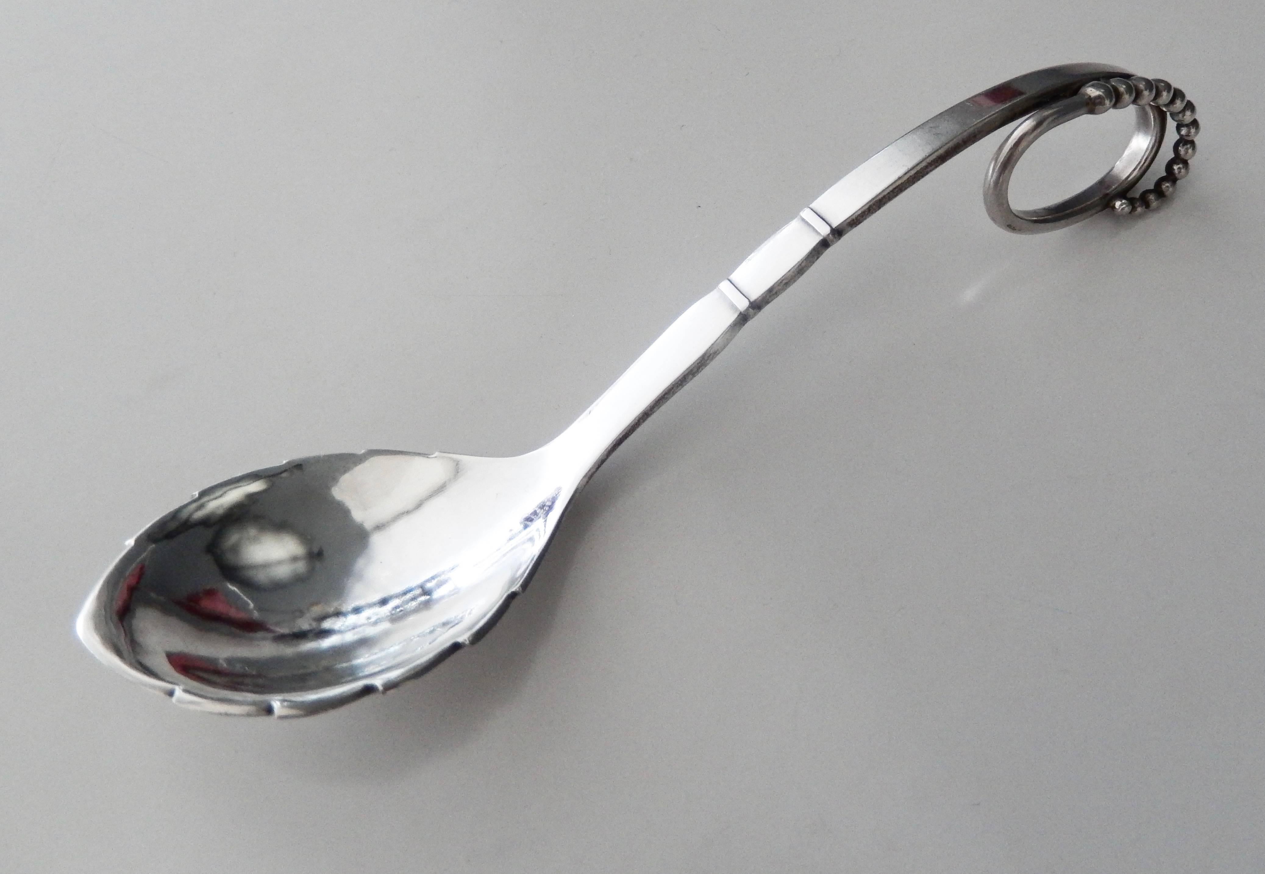 A vintage, hand-wrought, sterling silver jam spoon designed by Georg Jensen from the beginning of the 20th century. Jensen pieces from this early period of production are scarce. A beautiful, organic form by a master silversmith, in excellent