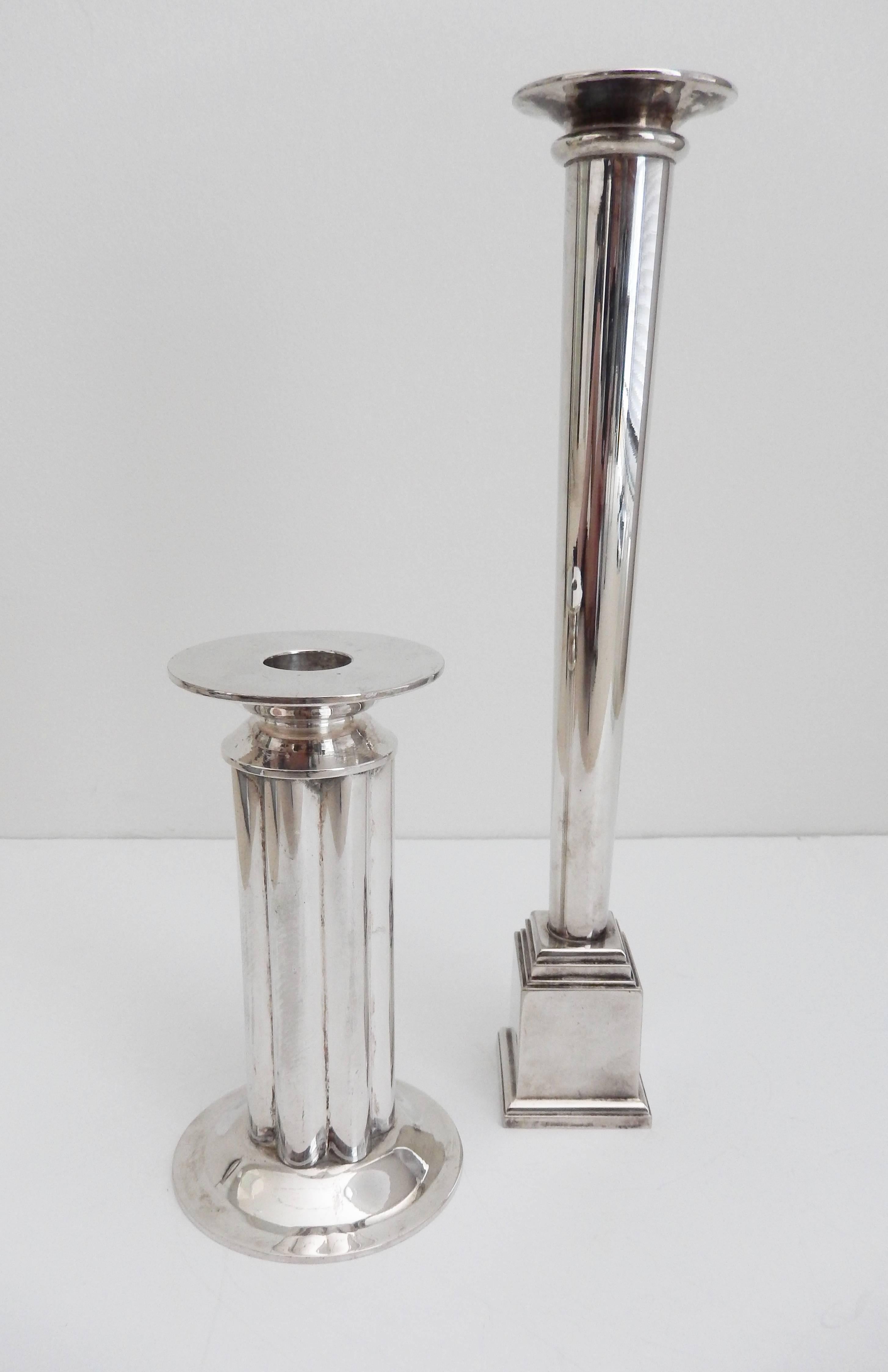 Two impressive silver plated candlesticks designed by the postmodernist architect Robert A. M. Stern (b. 1939) for Swid Powell. The columnar designs reflect Stern's interest in classical modernism. Both signed with impressed signature and marked