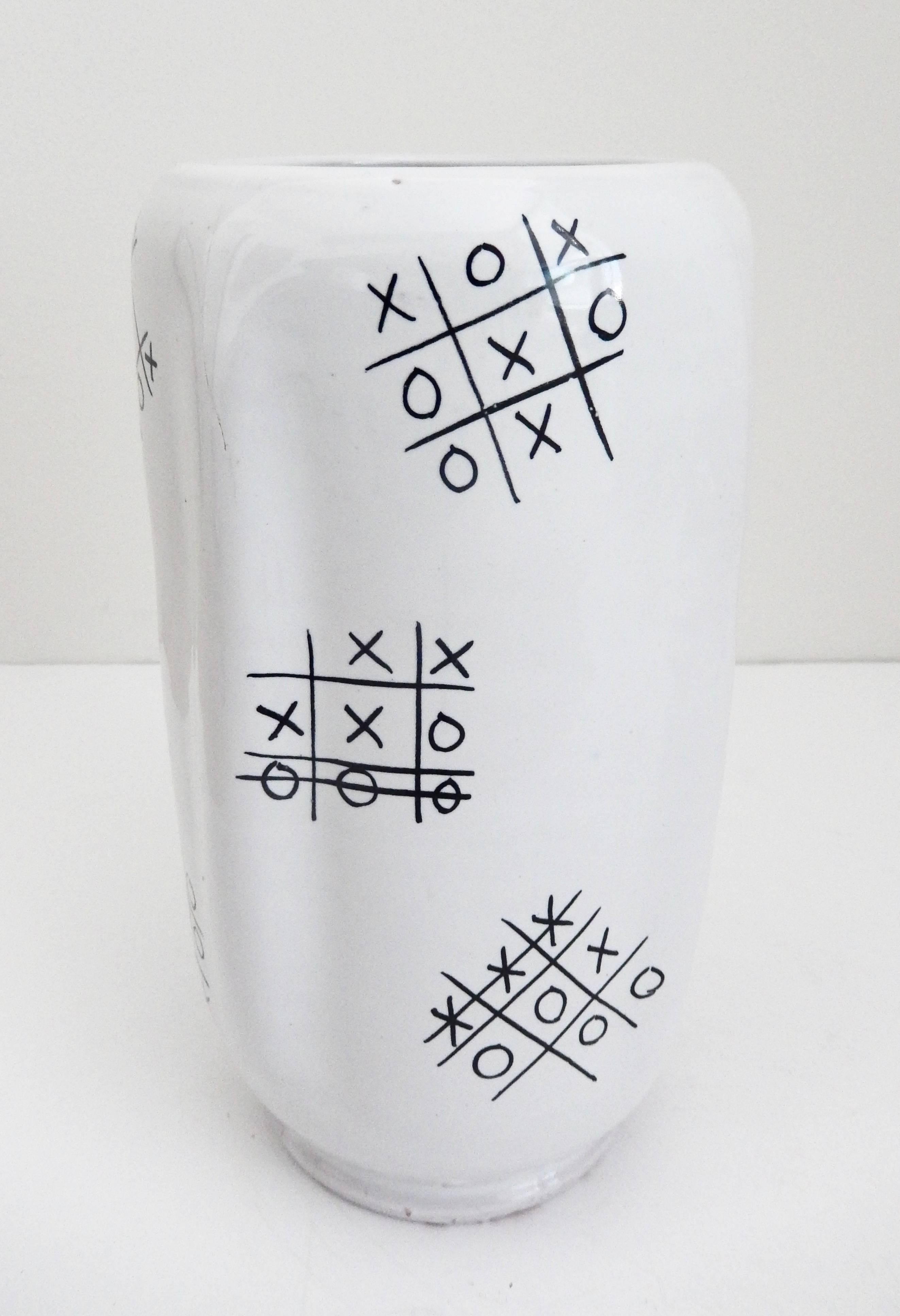 A scarce, modern vase by Ed Langbein with a very original and witty design of several tic-tac-toe games, resembling Graffiti. Since games are shown won by both players and some a draw, perhaps Langbein is trying show that tic-tac-toe is not always a