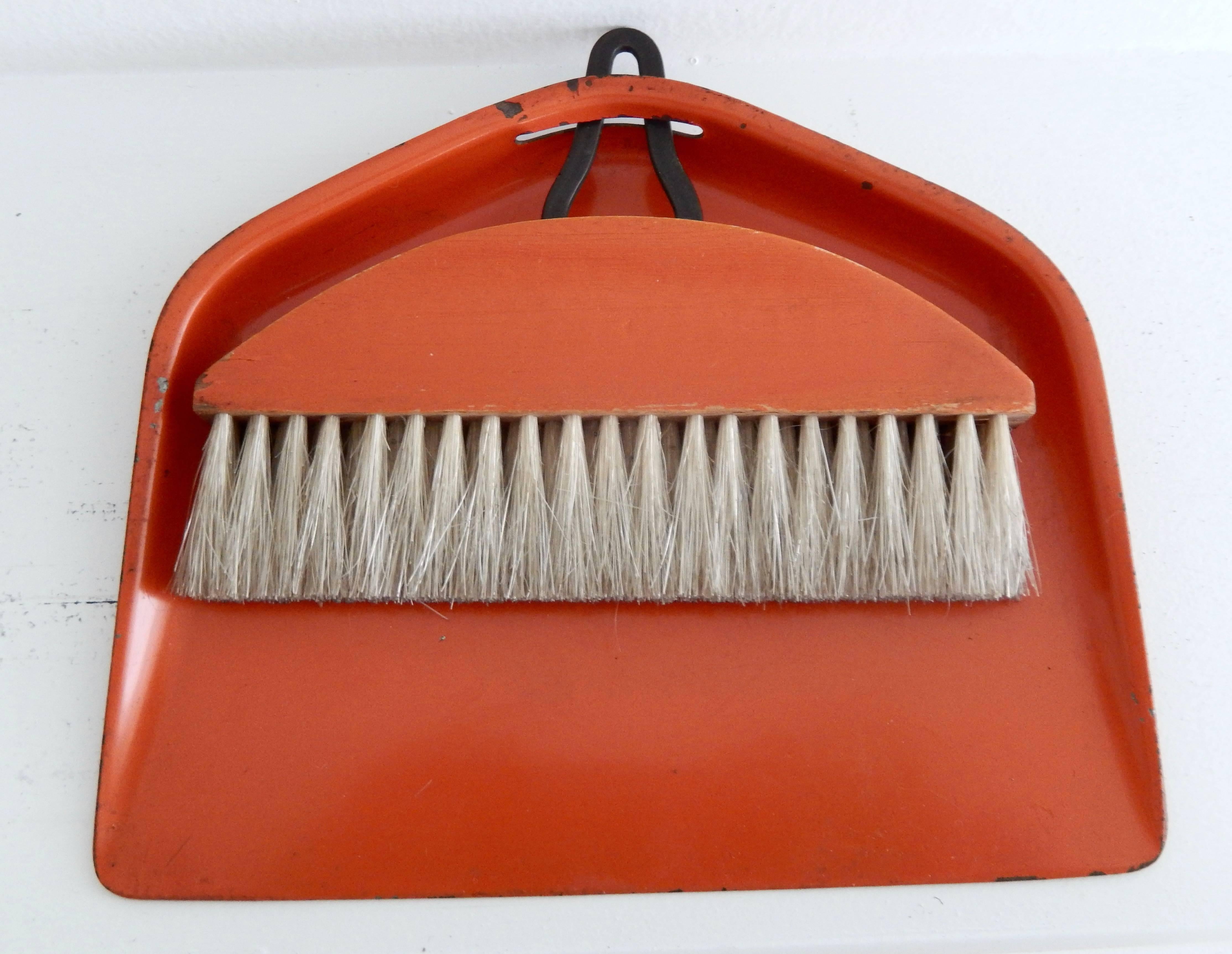 A burnt orange enameled sheet metal and horsehair brush and tray by the Bauhaus artist and Industrial designer Marianne Brandt (1893-1983). A functional, simple design exemplifying the best of Bauhaus metalwork. A fine example of pre-war modern