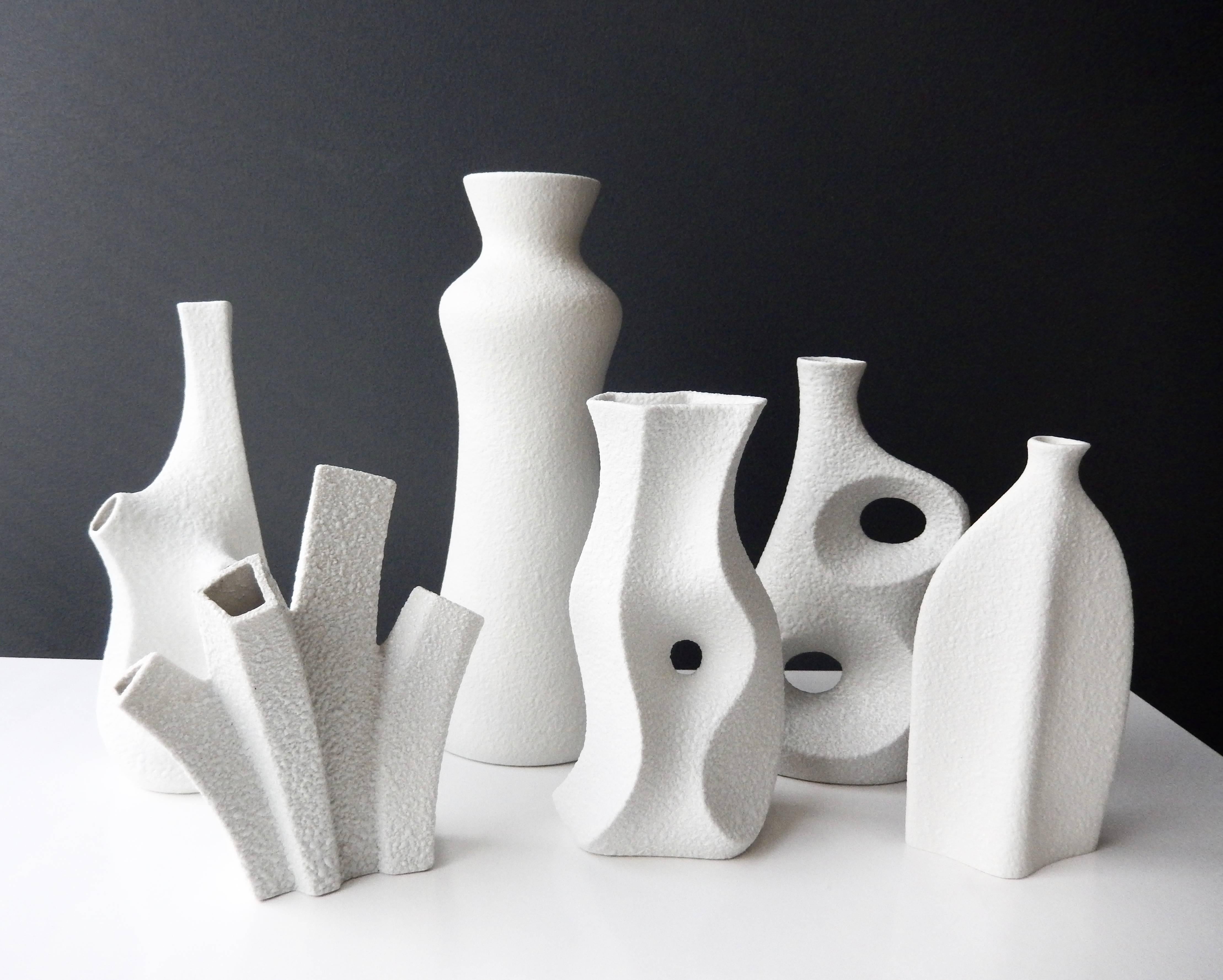A group of six white porcelain vases by the innovative designer Peter Muller for Sgrafo Modern.

In 1955 two brothers, Peter and Klaus Muller opened a small porcelain factory in Germany and created some of the most modern, futuristic-looking