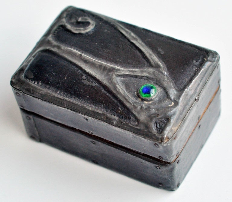 An unusual Art Nouveau wooden stamp box that has been wrapped with a hand-wrought metal overlay depicting a stylized creature with a glass eye. The box has a beautiful patina and the fine metalwork design exemplifies the spirit of the time.