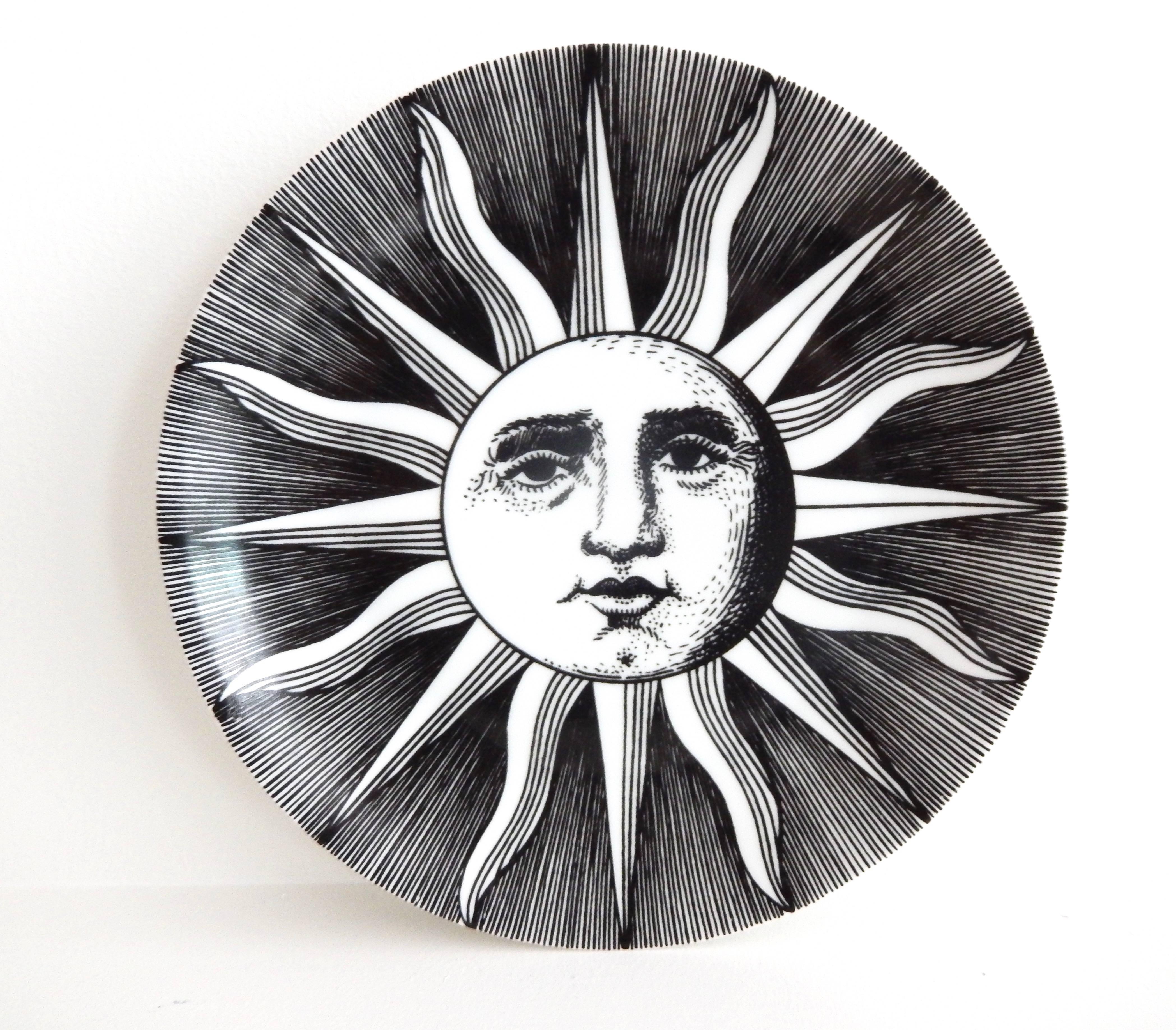 A pair of Fornasetti plates depicting one of his favorite motifs, the sun.
Also typical in Fornasetti's iconic work is his use of strong black and white graphics. Marked: 