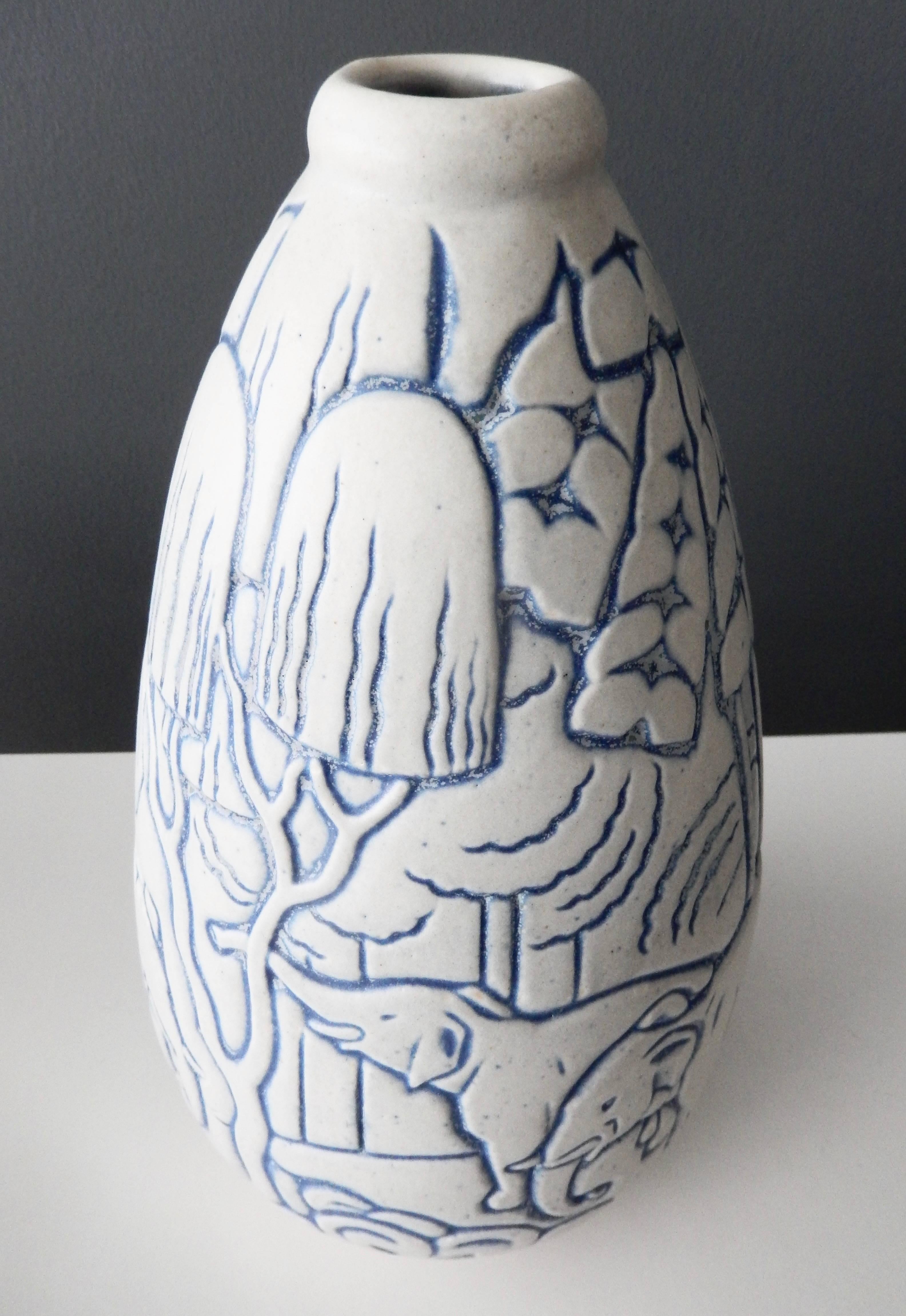 A tall, French Art Deco vase designed by Andre Legrand (1902-1947) for Les Freres Mougin (Joseph and Pierre Mougin), Nancy, France. As is typical of Mougin ceramics, the vase depicts stylized nature elephants in a natural, idealized setting of trees