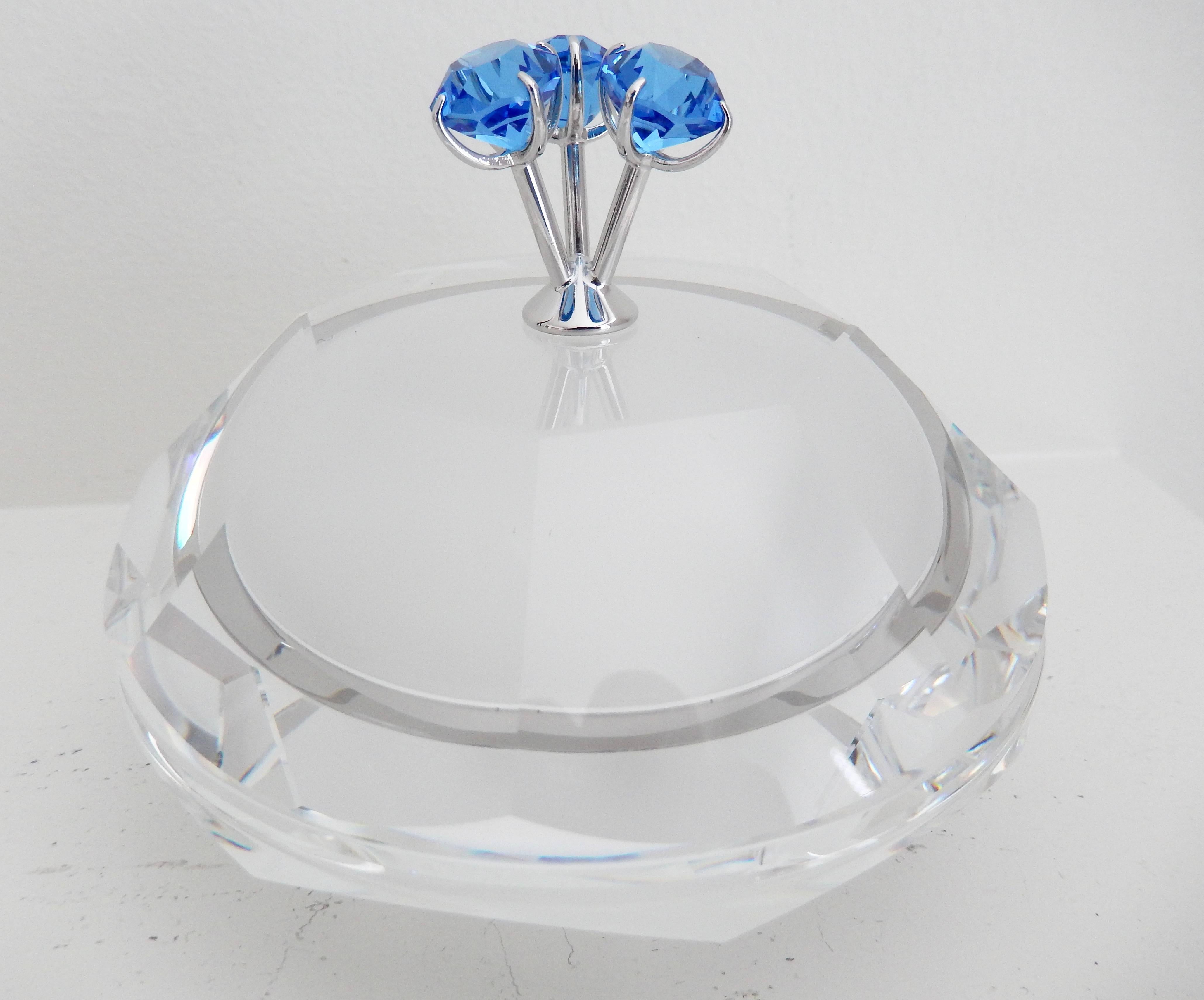 A sumptuous lidded box by the French design legend Andree Putman (1925-2013) for Swarovski crystal. The lid is adorned with three sapphire-colored crystals resembling space pods. Faceted crystal with a satin interior finish, simple but luxurious.