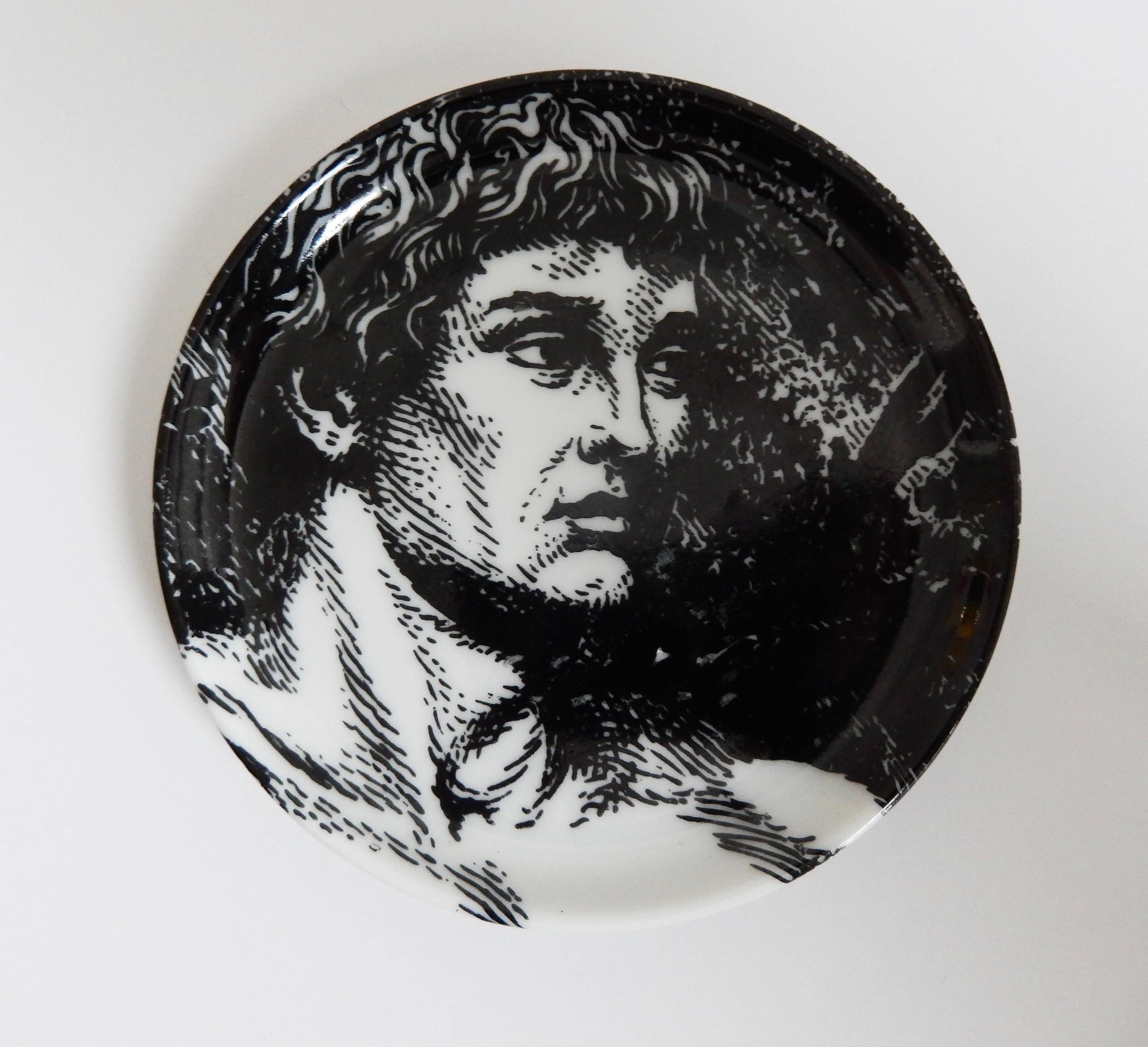 A complete set of eight Fornasetti coasters depicting a reclining, allegorical Adam. Fornasetti presents an interesting, interactive ceramic puzzle of the figure of Adam to be arranged by the viewer. This set is in excellent condition and includes