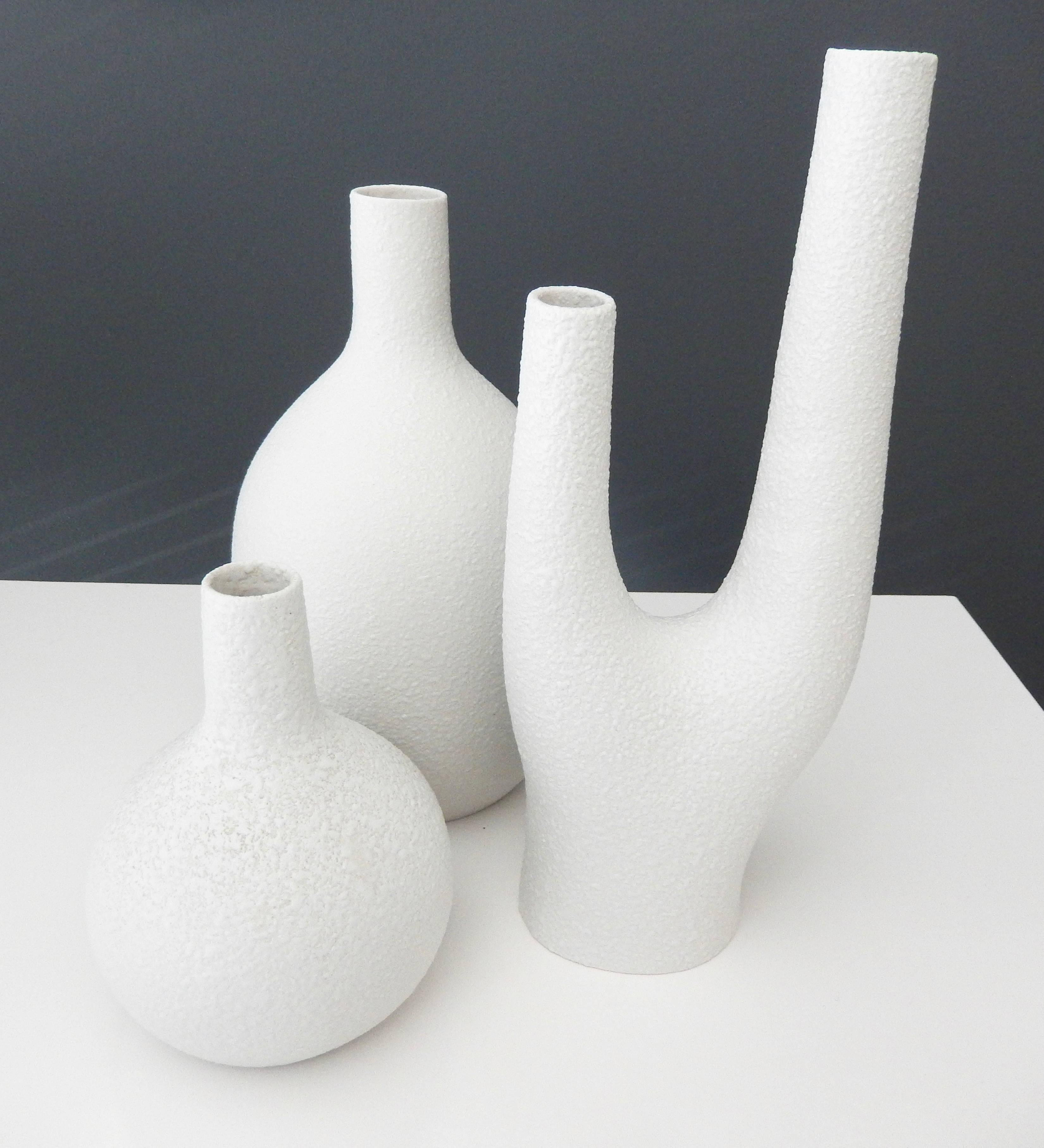 A group of three white porcelain vases by the innovative designer Peter Muller for Sgrafo Modern.

In 1955 two brothers, Peter and Klaus Muller opened a small porcelain factory in Germany and created some of the most modern, futuristic-looking