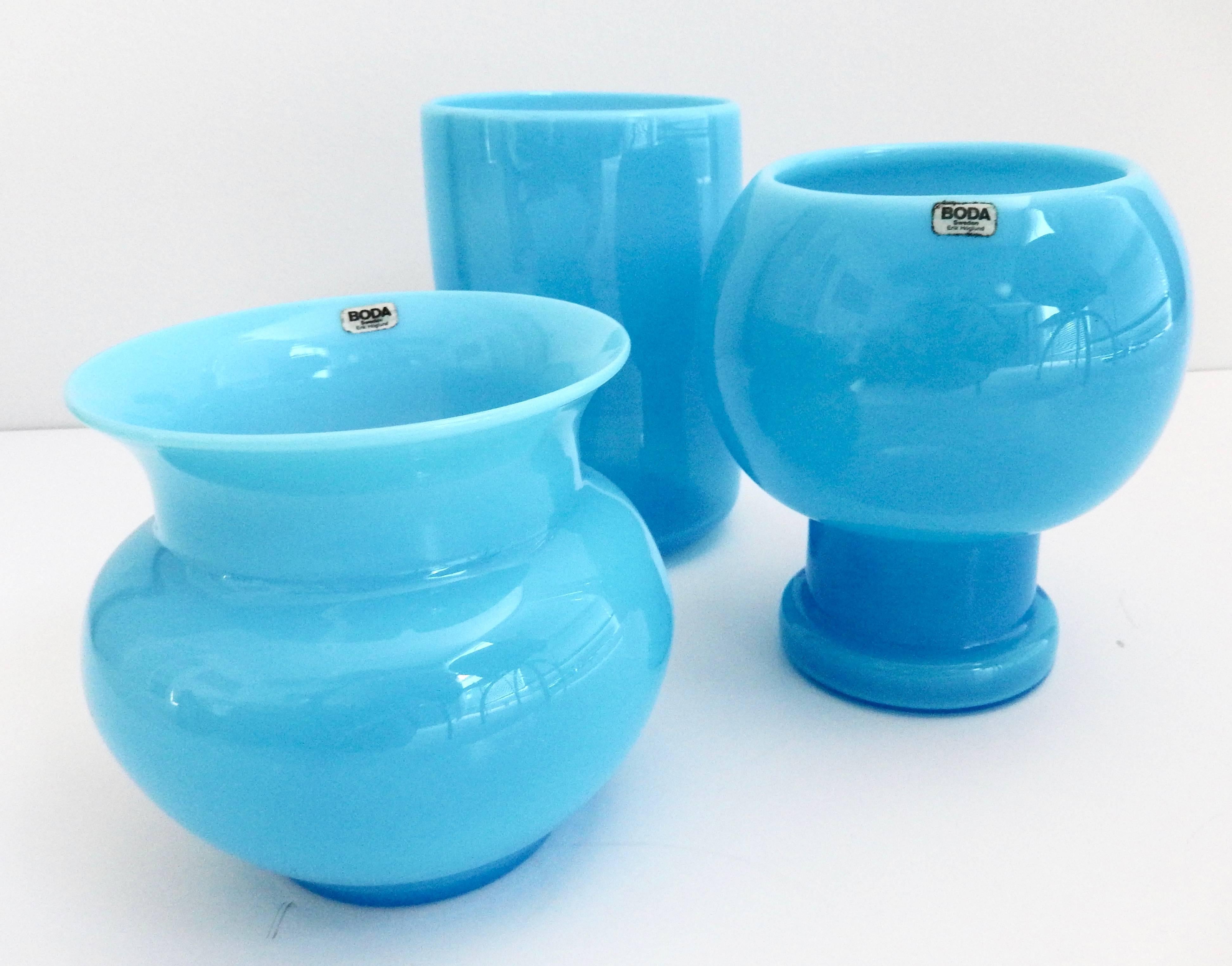 A collection of three opaque, richly-colored blue glass vases by the Swedish artist Erik Hoglund (1932-1998). Hoglund, a sculptor and graphic artist best-known for his innovative glass designs, collaborated with Boda Glasswork from 1953-1973. All