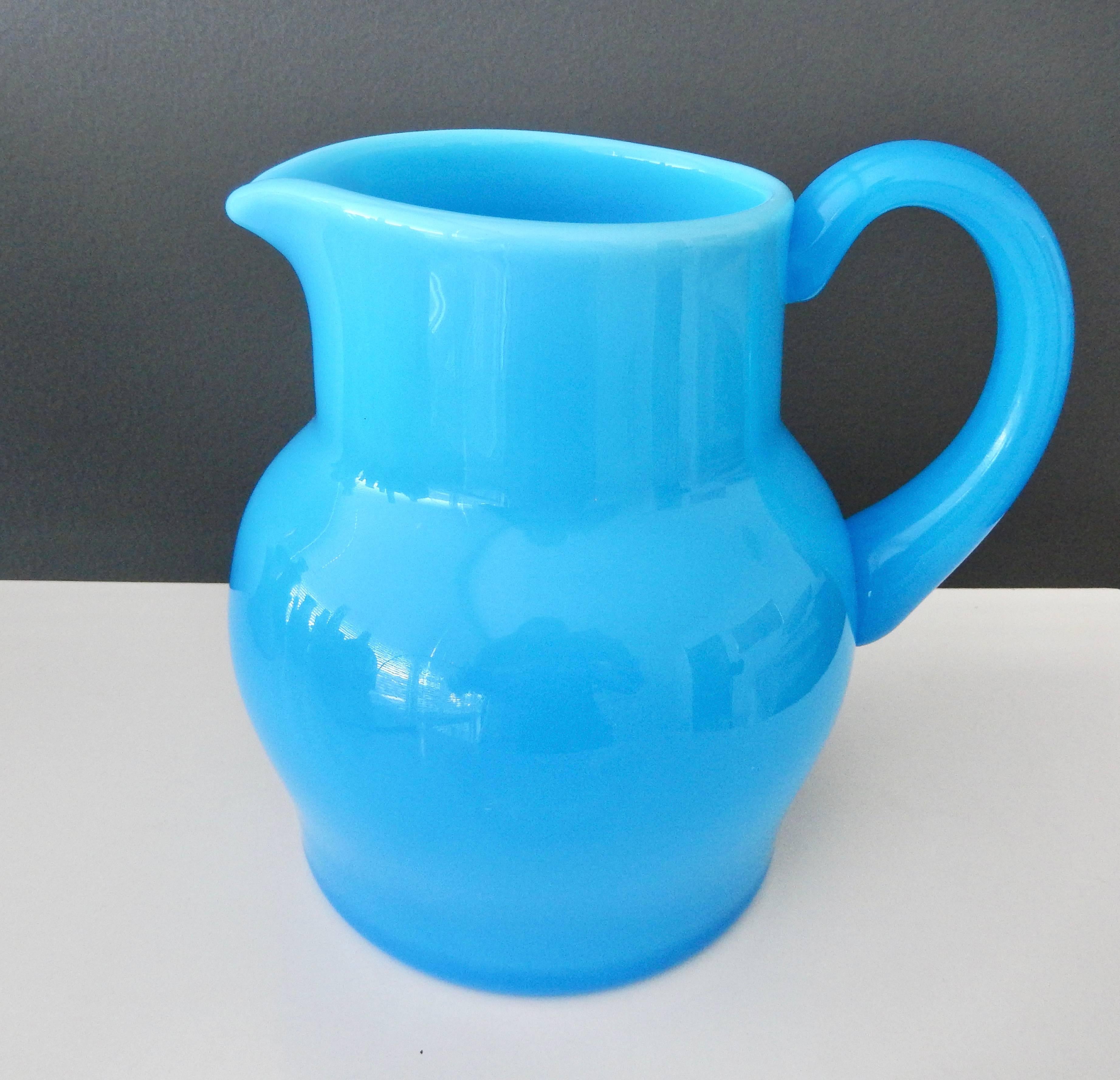 A scarce, opaque blue glass pitcher by the Swedish artist Erik Hoglund (1932-1998).  A simple, elegant example of modernist glass by this Swedish master.  Signed.

Reference:  A similar piece is in view in the Miller House, Indianapolis Museum of
