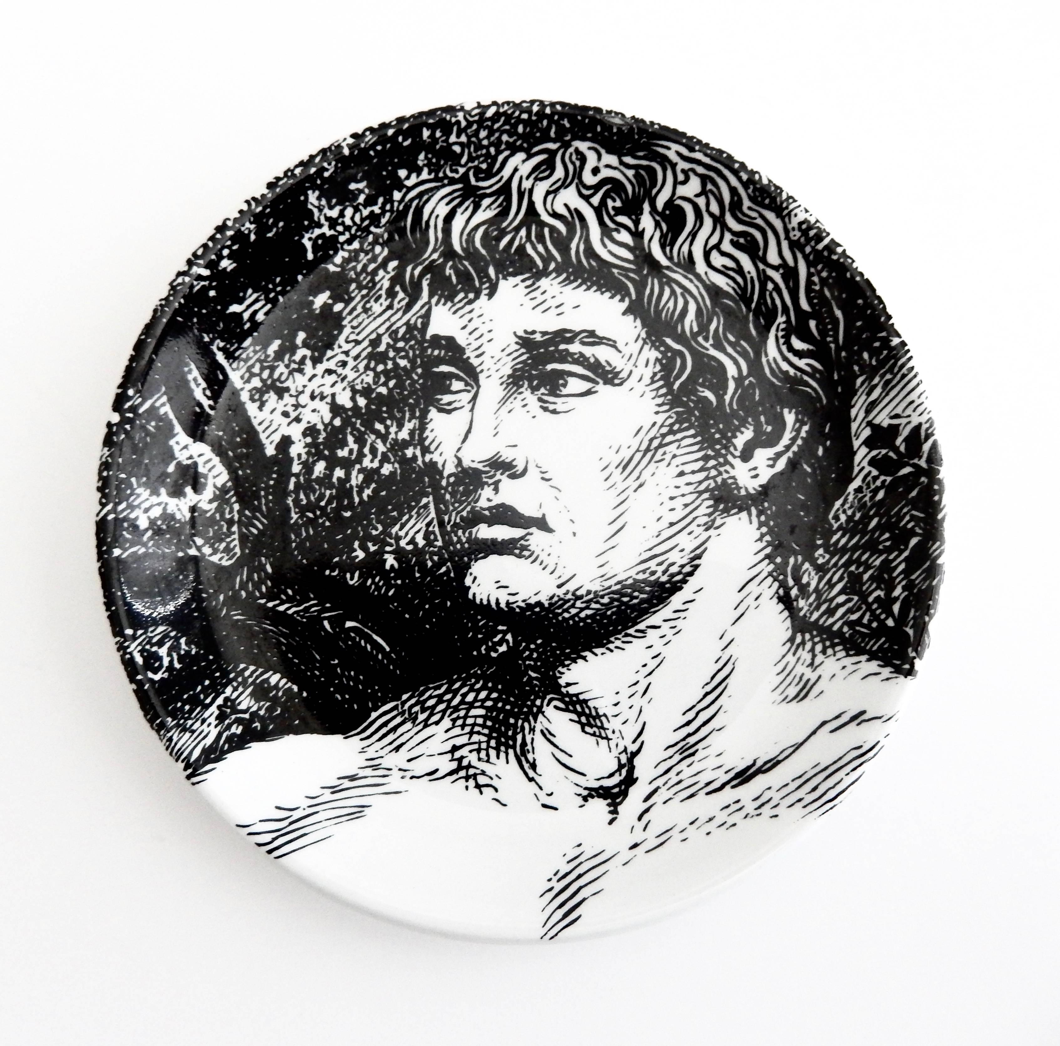 A complete set of eight Fornasetti coasters depicting a reclining, biblical Adam. Fornasetti has created a fascinating, interactive ceramic jigsaw puzzle of the figure of Adam to be arranged by the viewer. This set is in excellent condition and