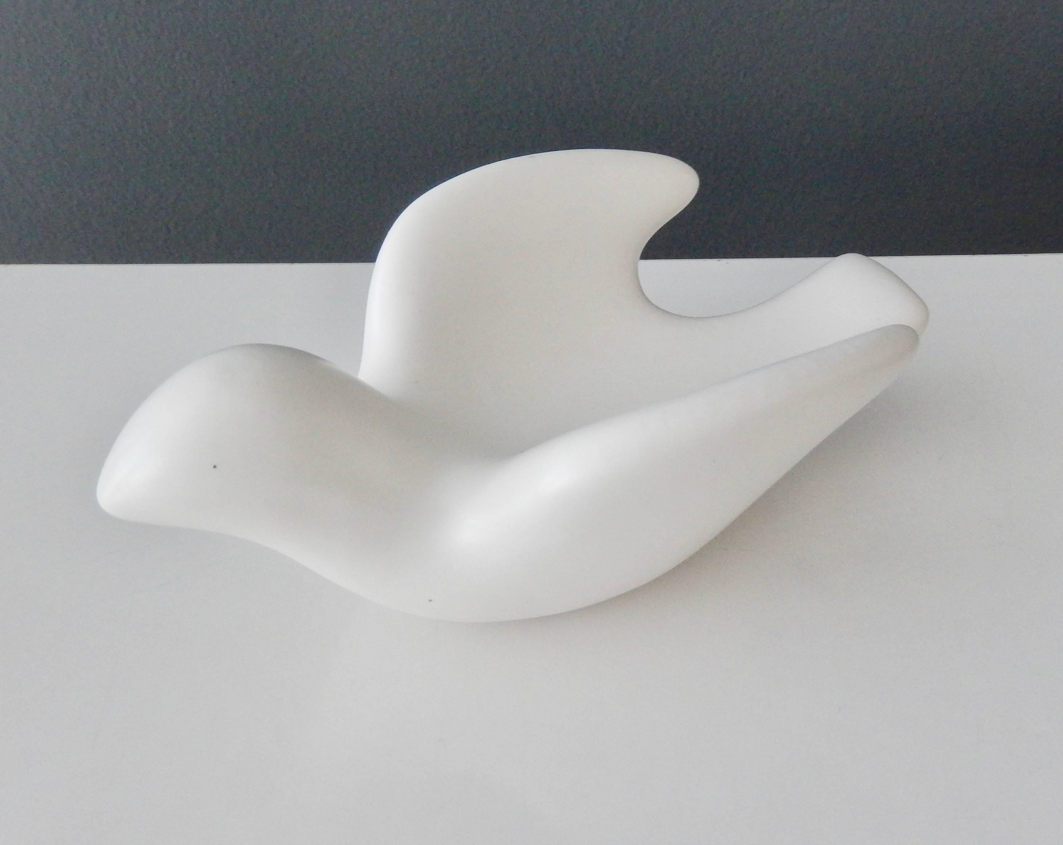 A stylized, white glazed ceramic 