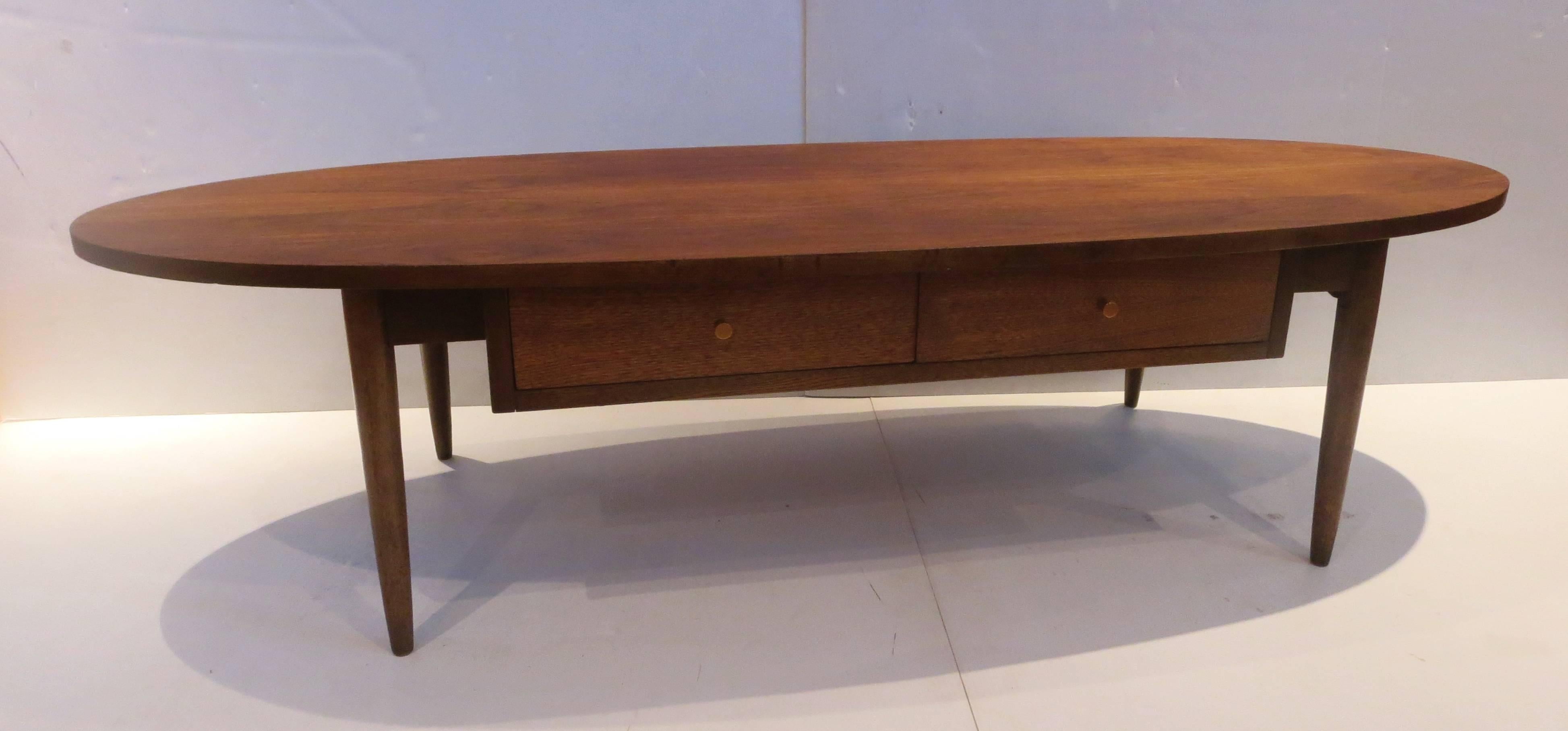 Simple and unique on this beautiful American walnut coffee table, circa 1950s in the style of Paul McCobb, freshly refinished, solid and sturdy nice condition. With two single small drawer compartments.
