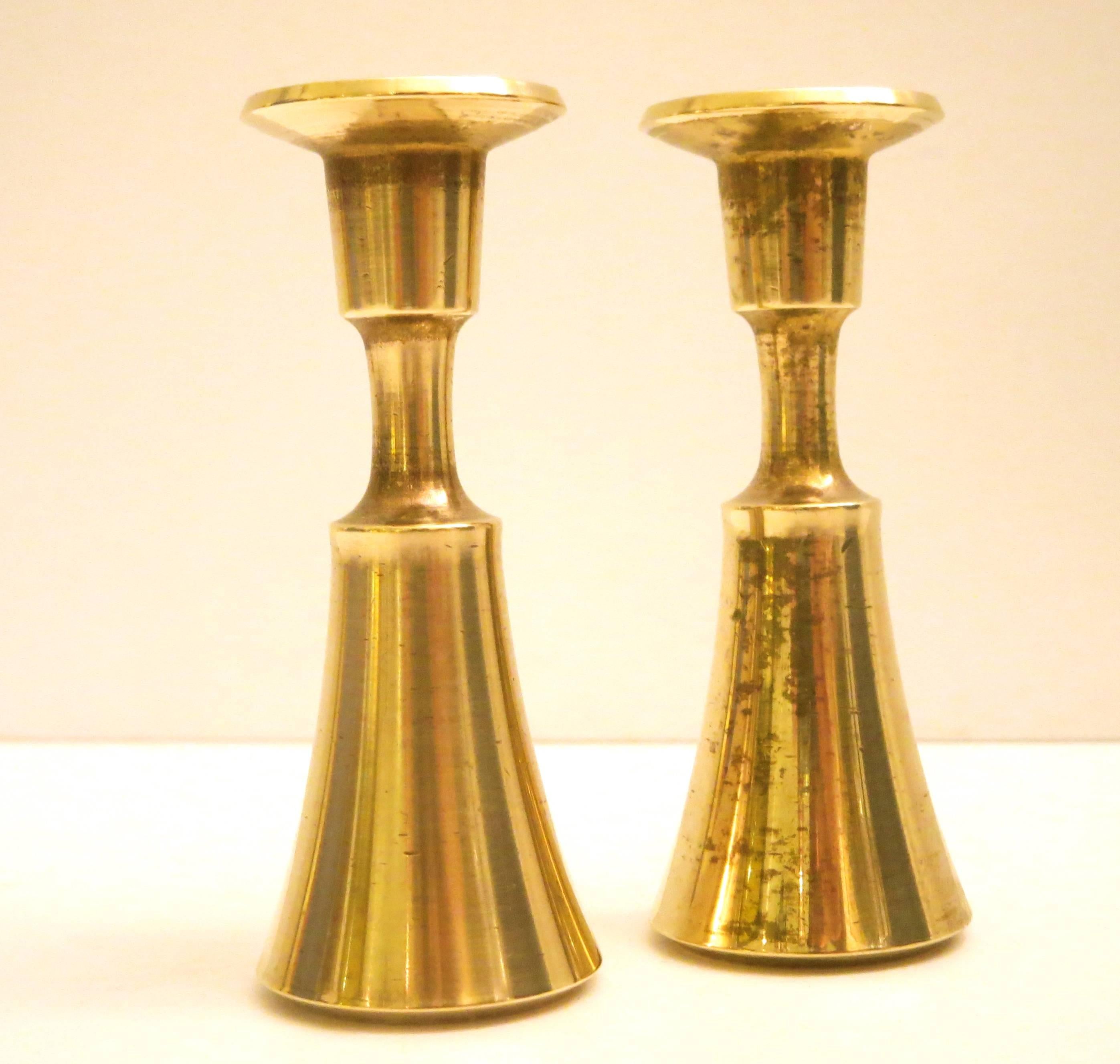 Nice set of small candle holders designed by Quistgaard for Dansk, early production, nice polished brass that fits long skinny tapper candles, great and simple design, nice and heavy stamped at the bottom nice light patina that can be polished, to