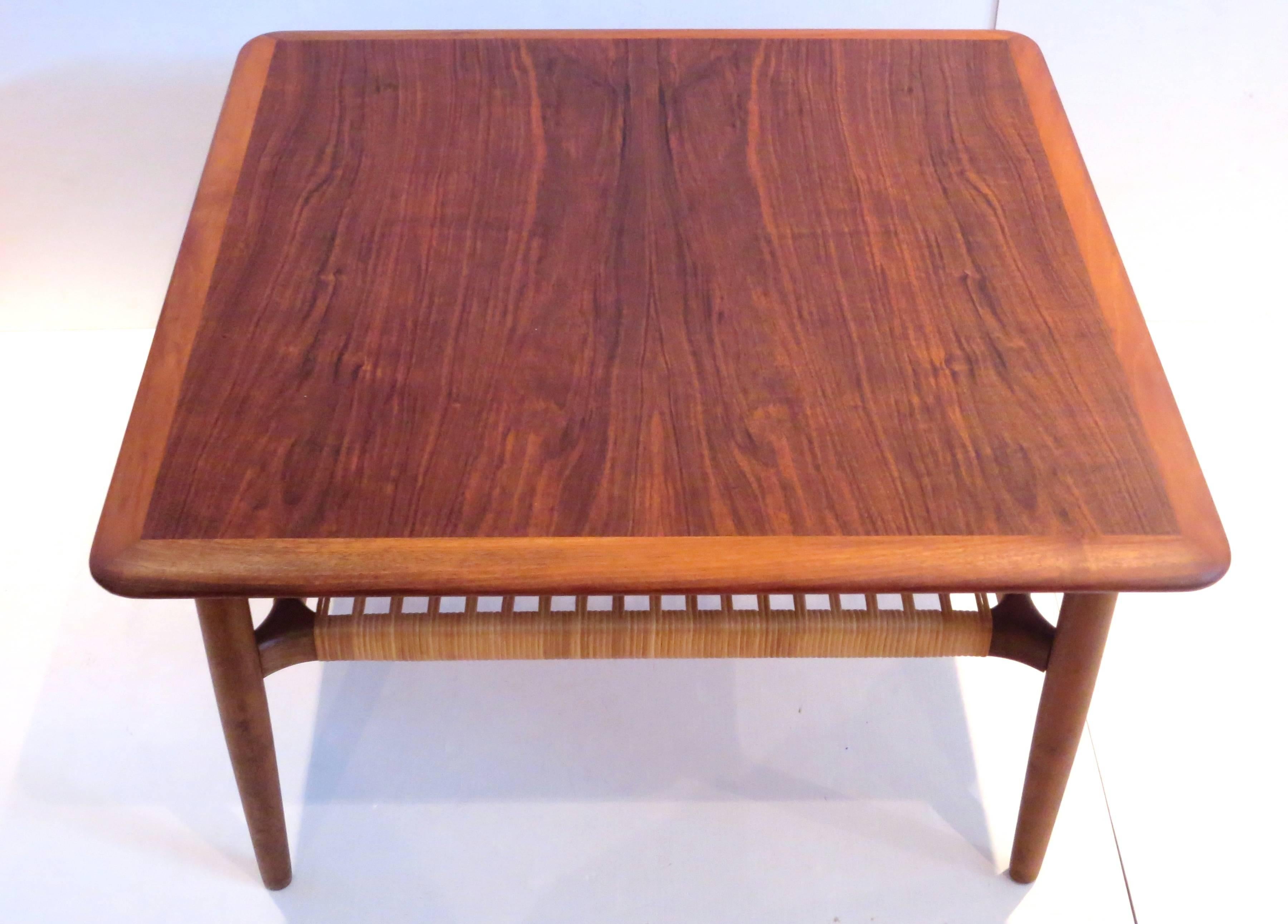Simple elegant beautiful square coffee table or cocktail end table designed by Gunnar Schwartz, in walnut with caned shelf excellent condition freshly refinished with Danish Control tag, circa 1950s solid and sturdy.