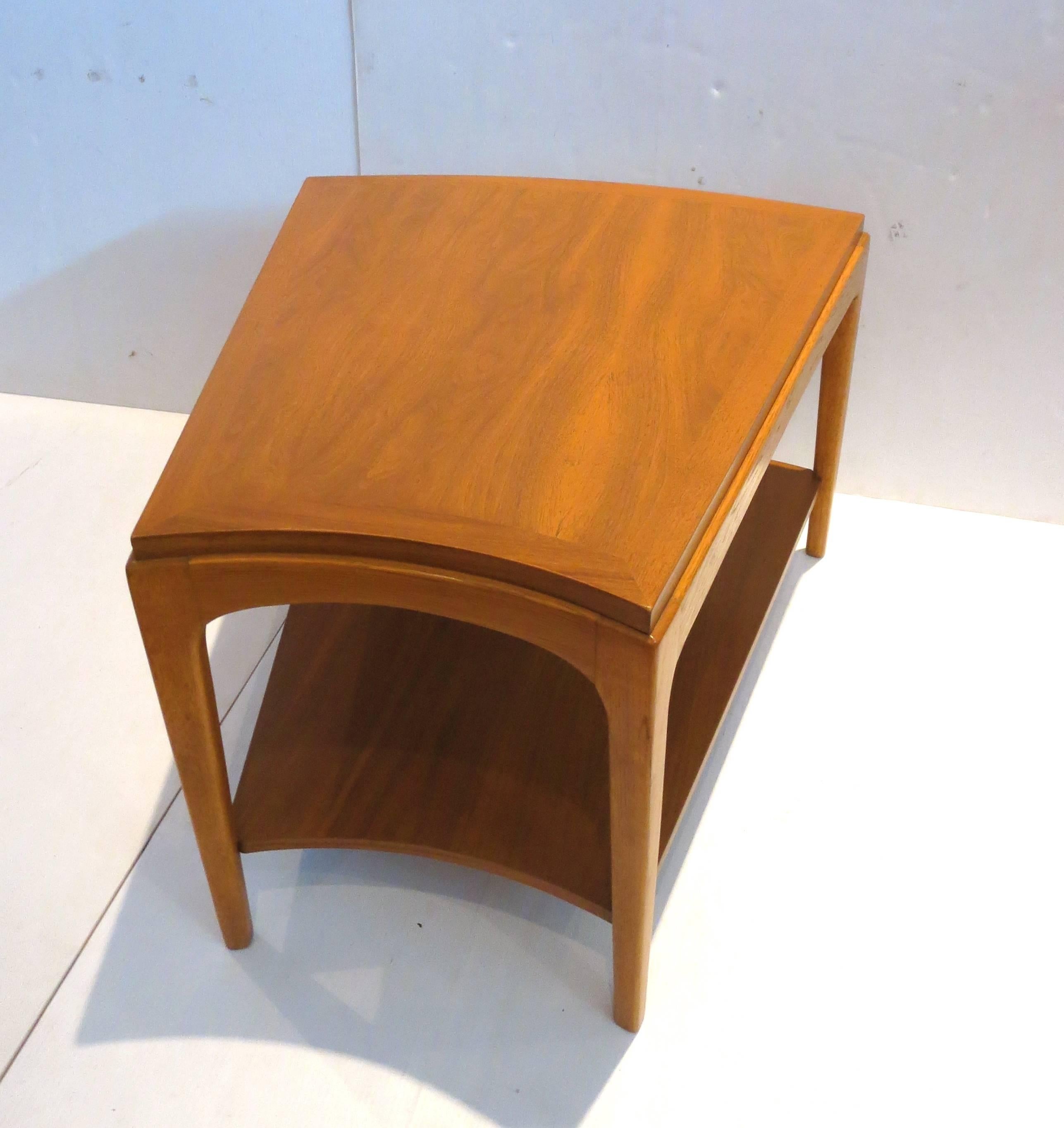 Nice and unique shape on this American Mid-Century Modern cocktail end table with shelf, circa 1960s in walnut freshly refinished solid and sturdy with curved back and front , perfect to be used as a corner table or in between two chairs.