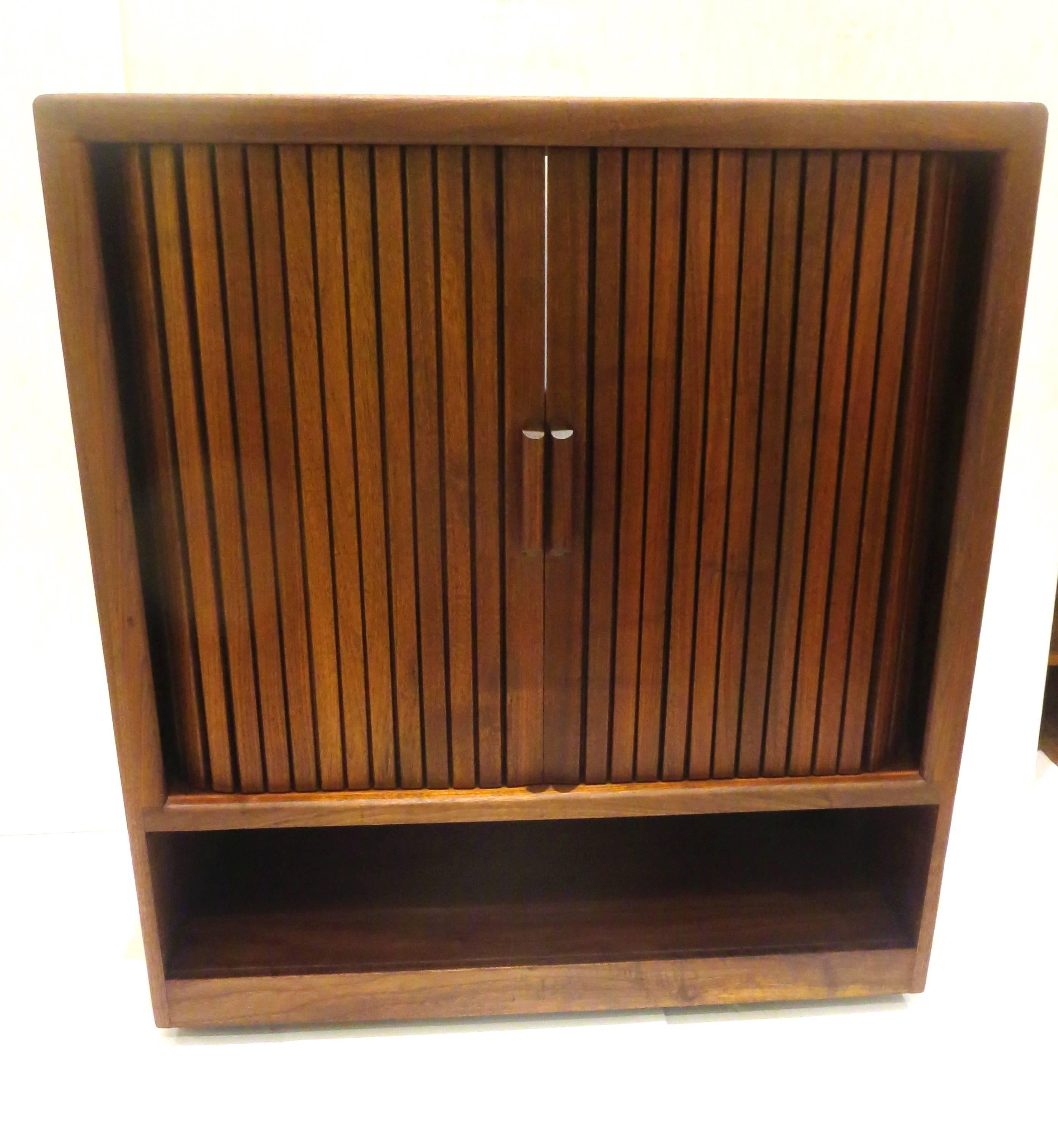 Great design on this solid walnut tambour door media cabinet designed by Lou Hodges, circa 1970s tambour door and lower compartment, for storage can be used as mini bar, or for records versatile and unique in nice freshly refinished walnut, sitting