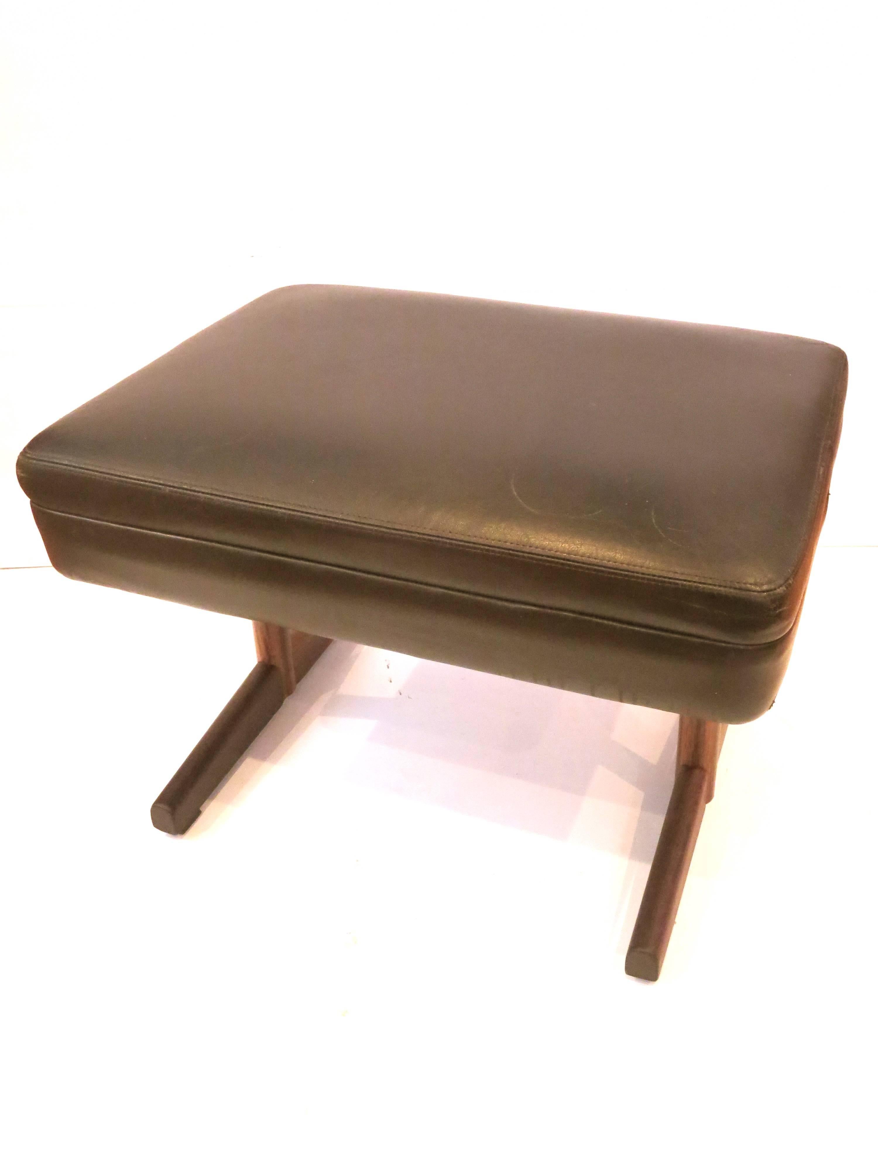Simple elegant original black leather stool or ottoman, circa 1950s hand-stitched leather top with solid rosewood base great original condition the base has been light sanded and oiled, solid and sturdy with iron attachments.