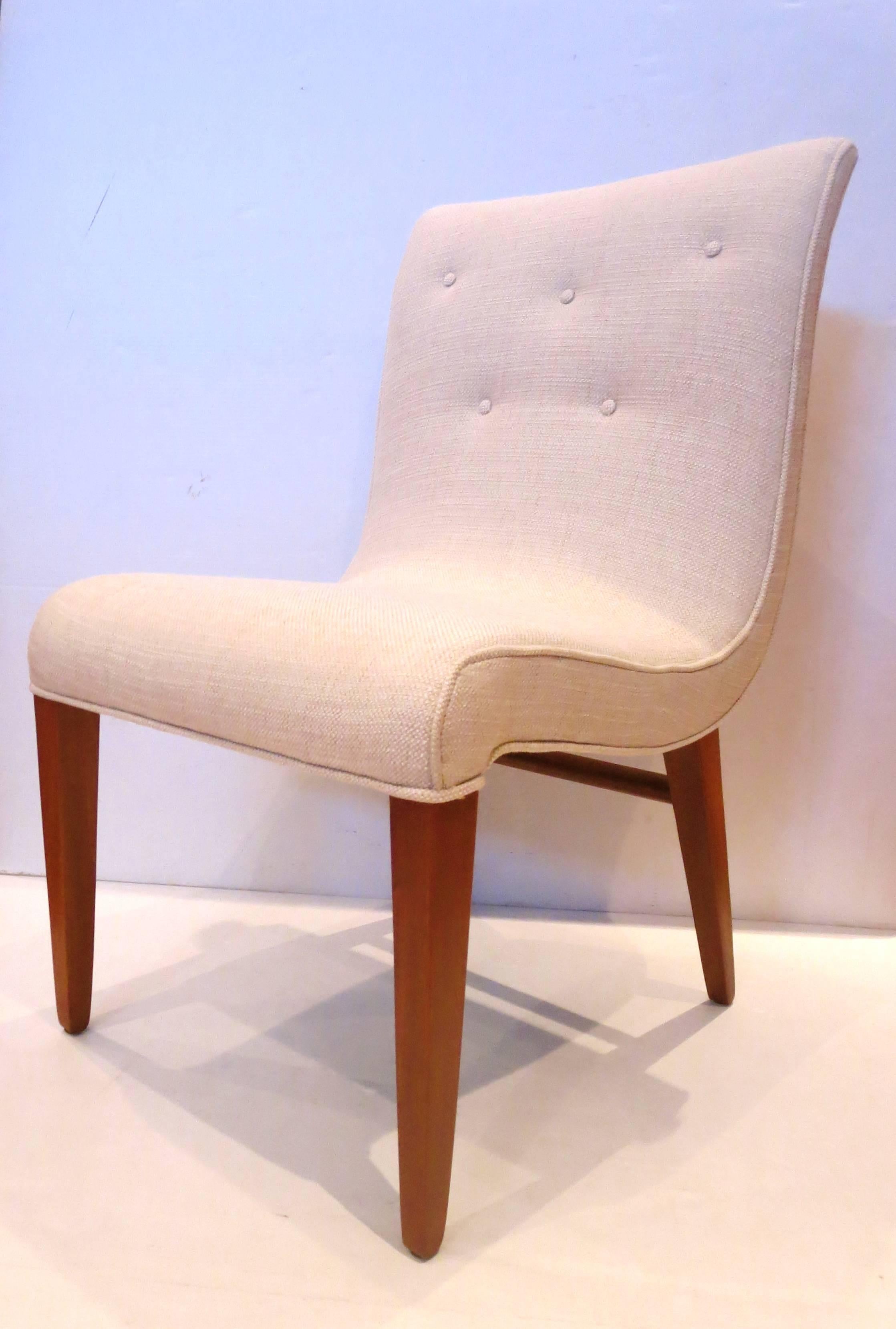 Beautiful and elegant lines on these set of four chairs, designed by Edward Wormley for Dunbar, circa 1950s freshly refinished in solid mahogany legs , and recover in a cream color tweed fabric, neutral color that matches anything, solid and sturdy.
