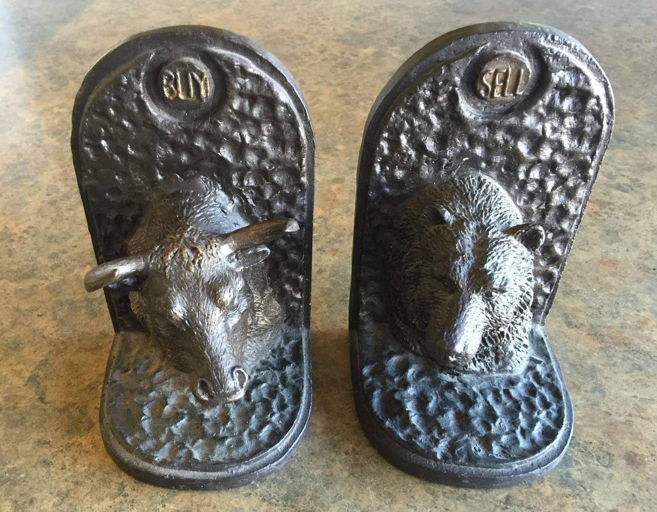 Very heavy vintage pair of bas-relief bear/bull iron bookends. The bull has a 