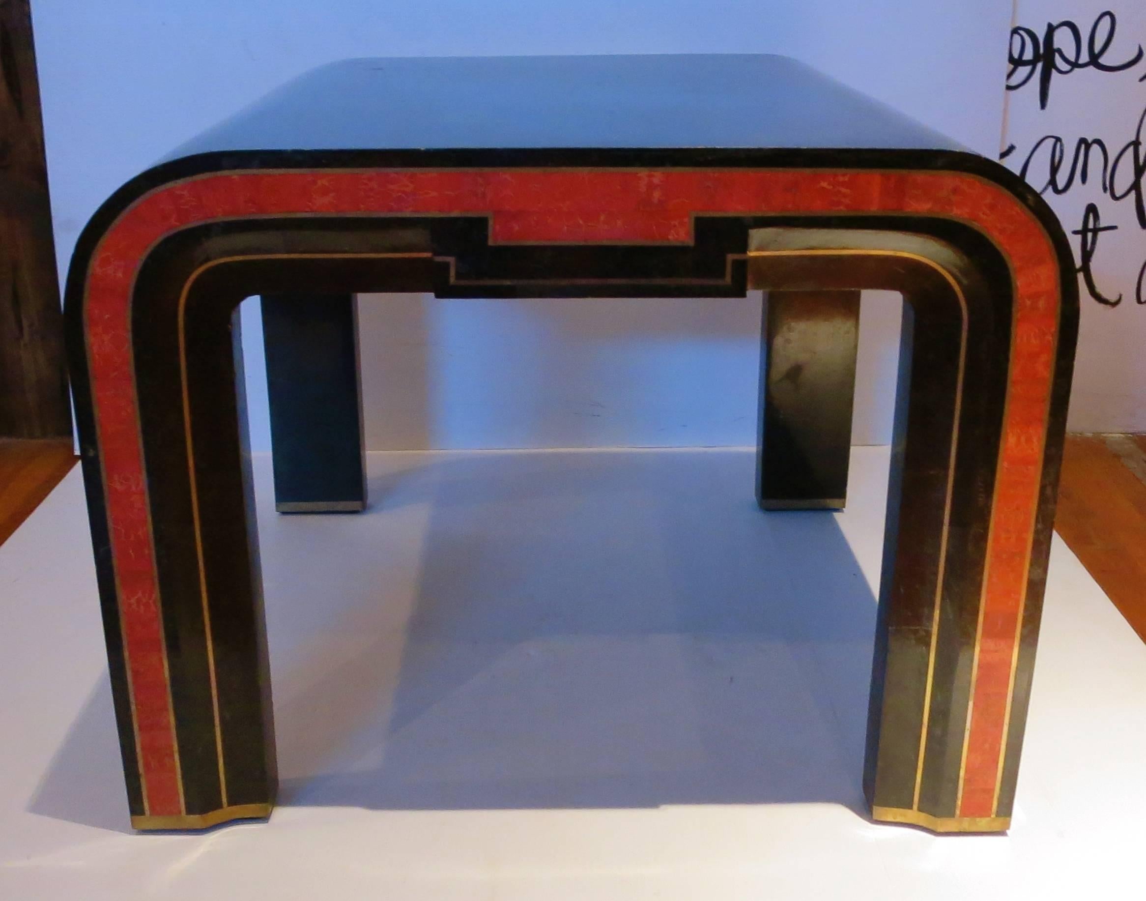 Finely crafted red coral and black tessellated marble side table with seamless brass inlay. A very rare table, circa 1970s. Can be used in between two club chairs or in a corner.